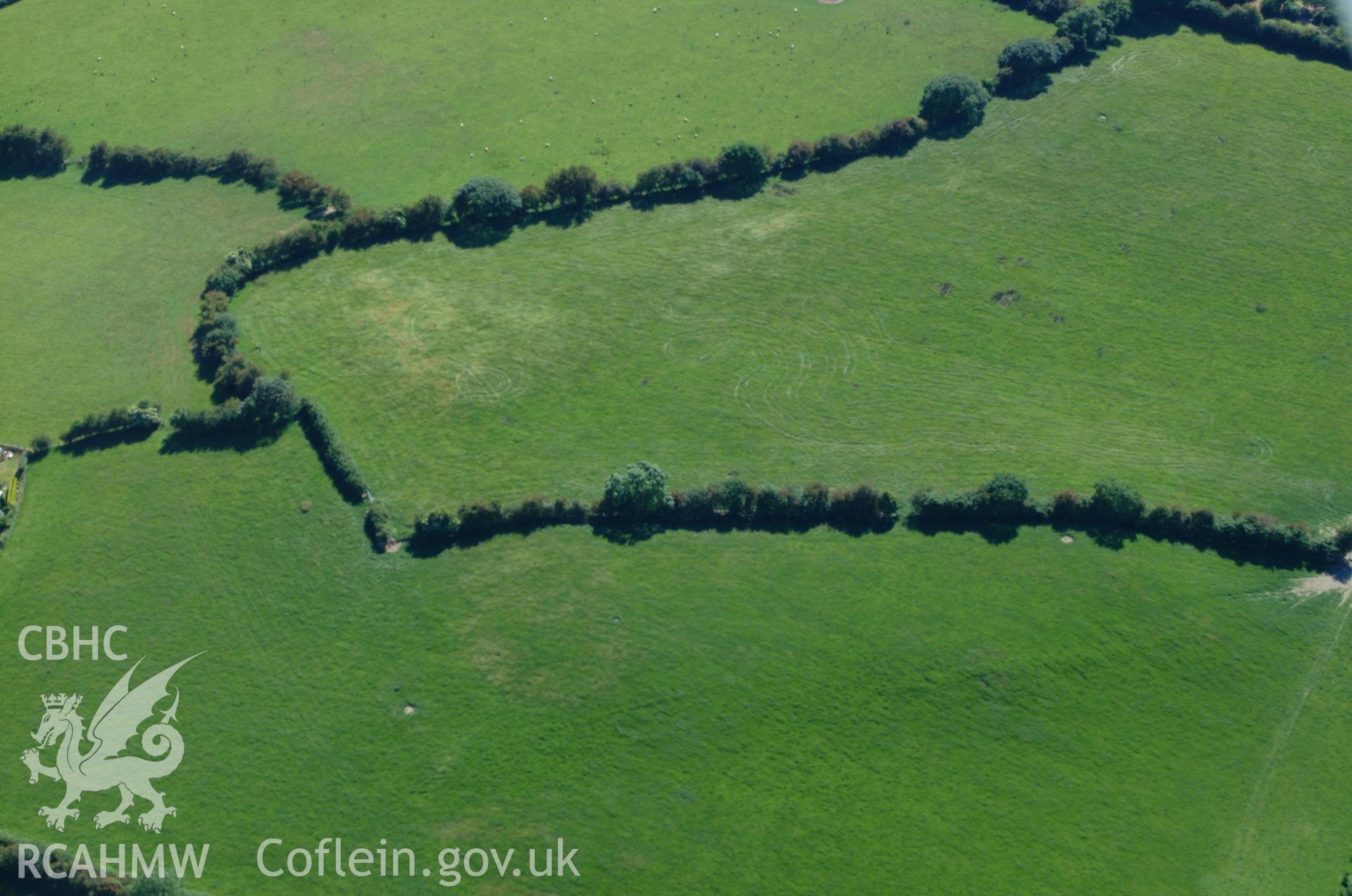 RCAHMW colour oblique aerial photograph showing site of Pen-Llwyn Roman Fort. Taken on 14 June 2004 by Toby Driver