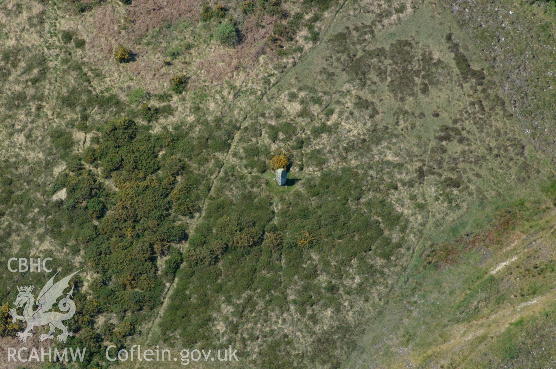 RCAHMW colour oblique aerial photograph of the standing stone and excavated features at Rhos-y-clegyrn taken on 25/05/2004 by Toby Driver