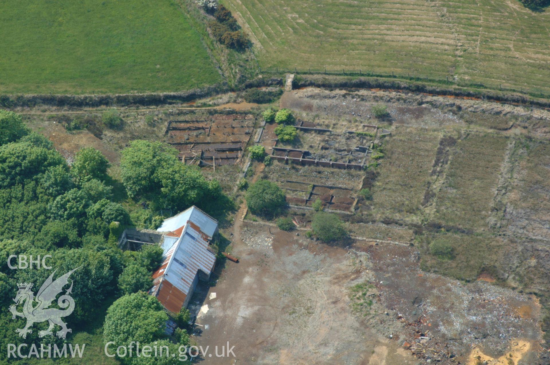 RCAHMW colour oblique aerial photograph of Dyffryn Adda Reverbatory Furnace, Parys Mountain taken on 26/05/2004 by Toby Driver