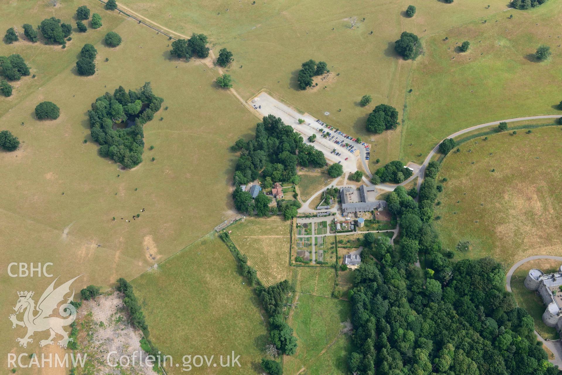 Car park and farm buildings at Chirk Castle. Oblique aerial photograph taken during the Royal Commission’s programme of archaeological aerial reconnaissance by Toby Driver on 10 July 2018.