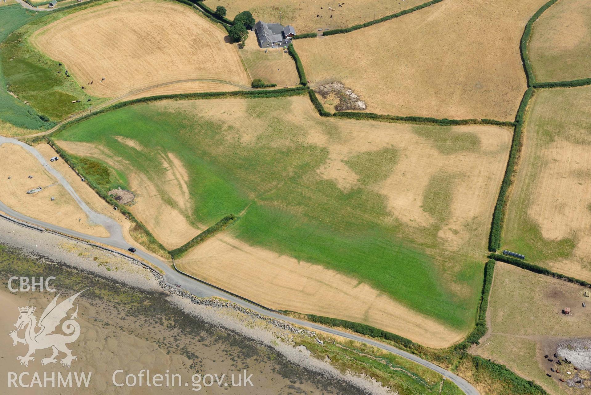 Glan y Mor cropmarks. Oblique aerial photograph taken during the Royal Commission’s programme of archaeological aerial reconnaissance by Toby Driver on 10 July 2018.