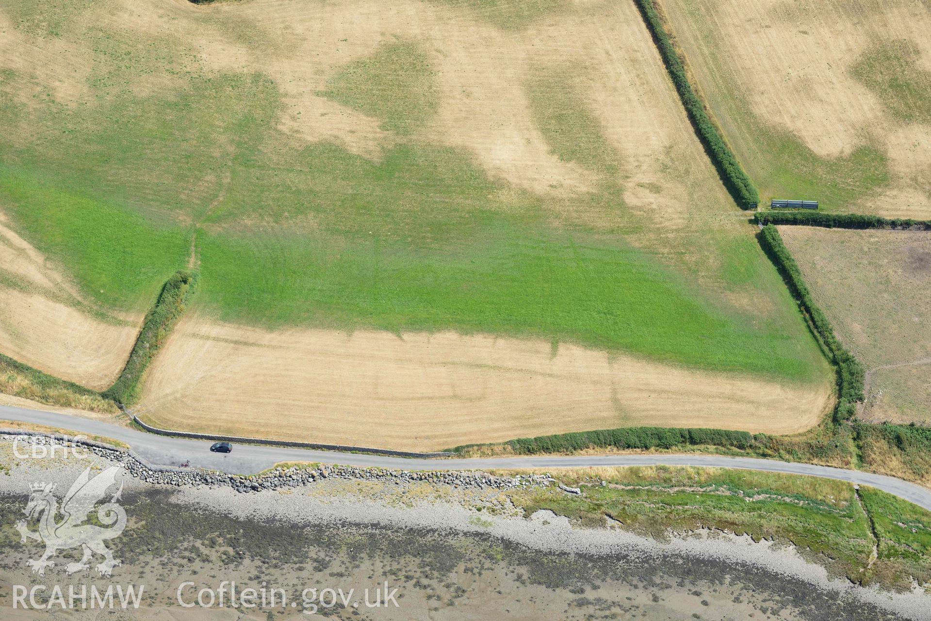 Glan y Mor cropmarks. Oblique aerial photograph taken during the Royal Commission’s programme of archaeological aerial reconnaissance by Toby Driver on 10 July 2018.