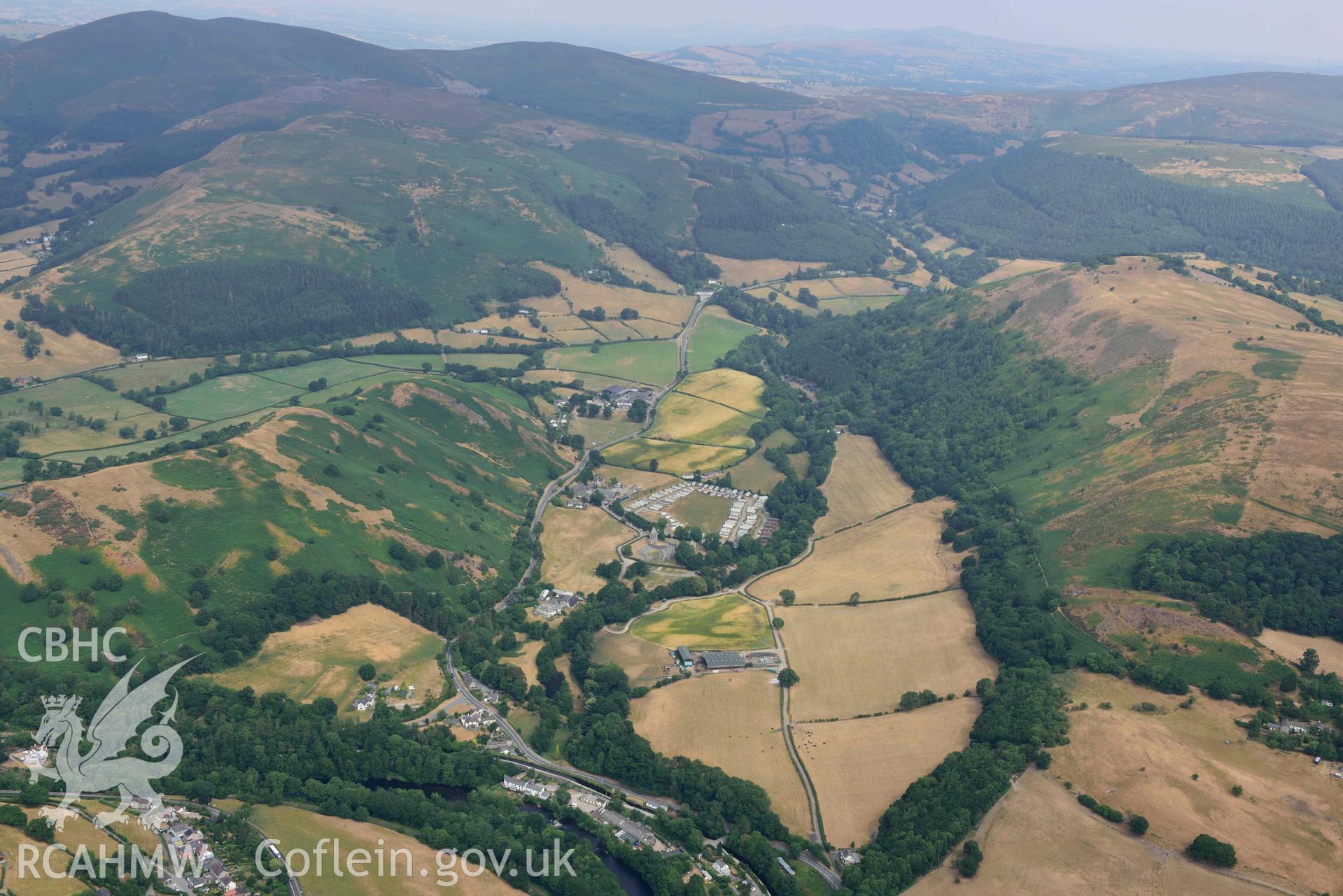 Vale Crucis Abbey and the Pillar of Eliseg. Oblique aerial photograph taken during the Royal Commission’s programme of archaeological aerial reconnaissance by Toby Driver on 10 July 2018.