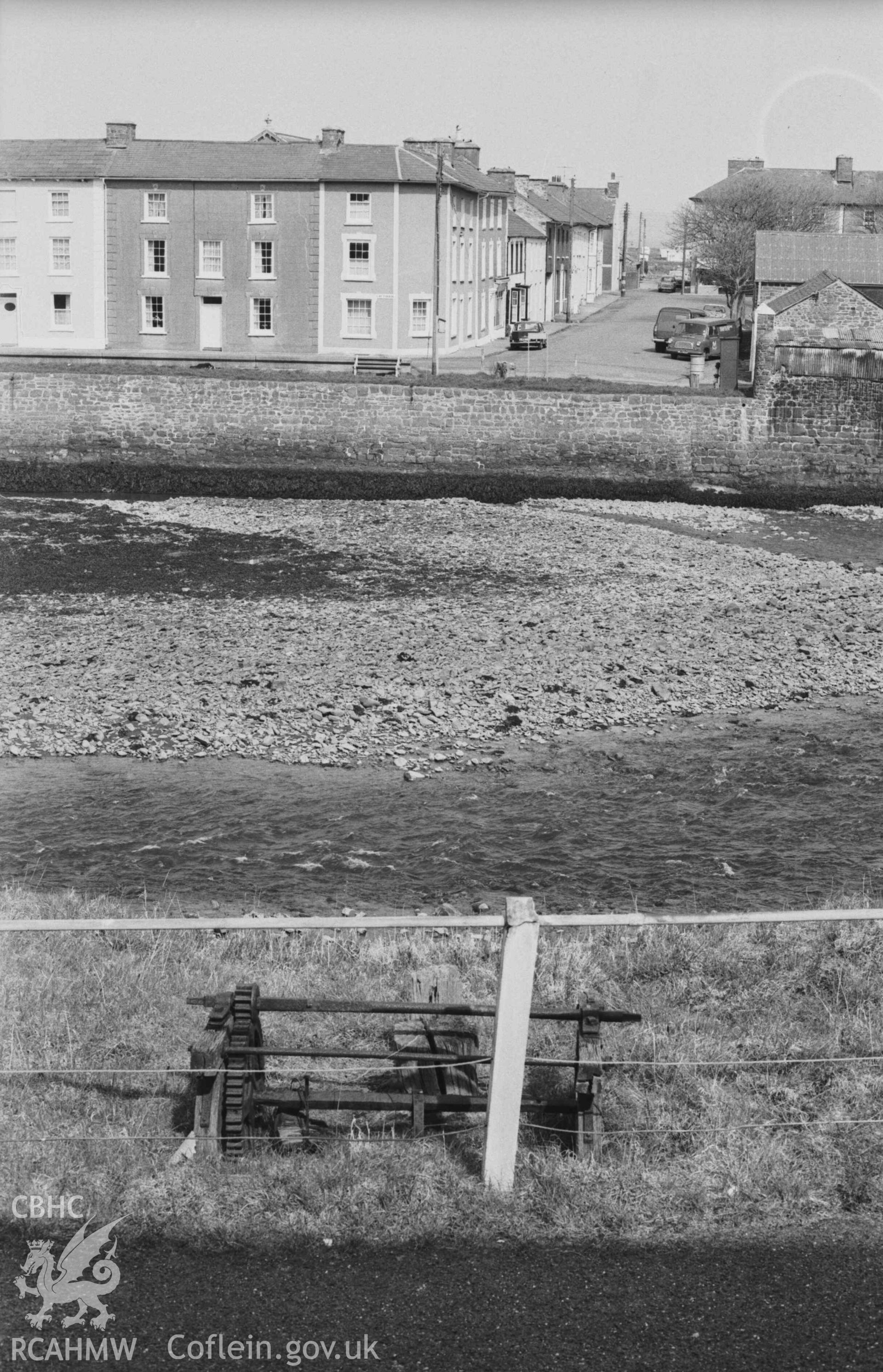 Digital copy of a black and white negative showing the route of the cable-car across Aberaeron harbour, and remains of winches at both ends. Photographed by Arthur Chater on 3 April 1969. Looking north from Grid Reference SN 4559 6285.