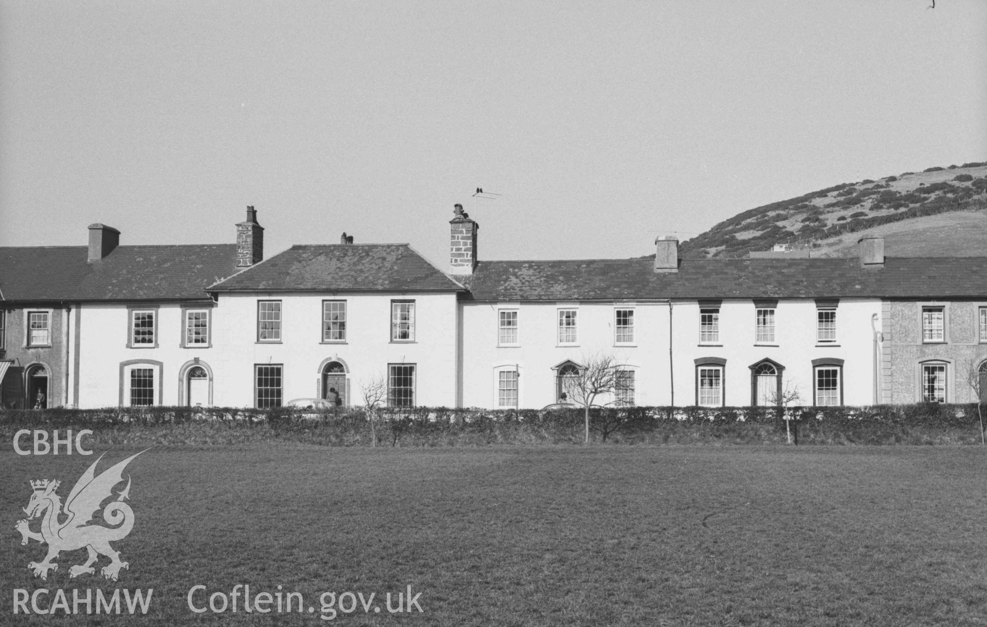 Digital copy of a black and white negative showing houses on the north east side of Alban Square, Aberaeron. Photographed by Arthur Chater on 3 April 1969. Looking north east from Grid Reference SN 4596 6283.