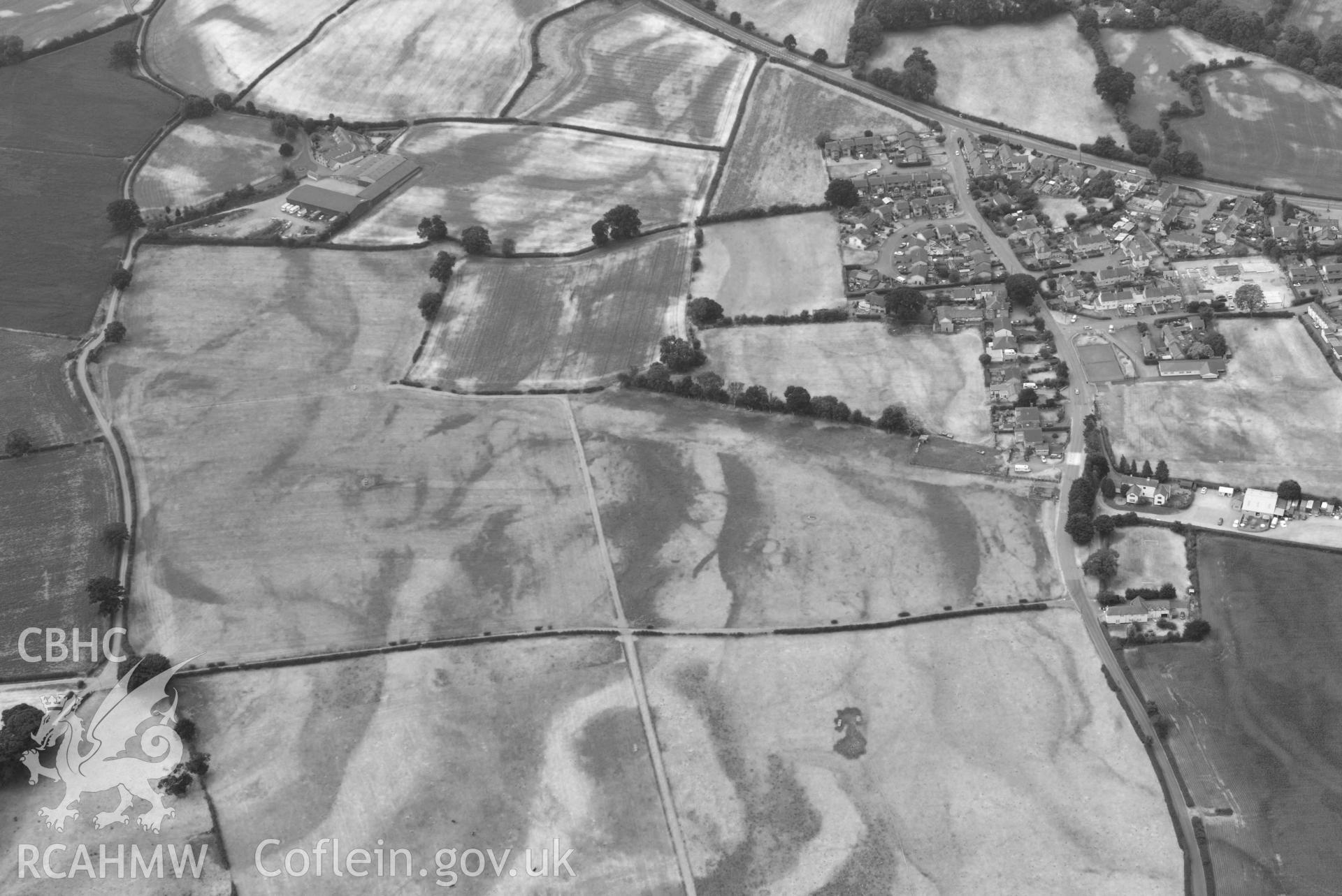 Rhewl round barrows complex. Oblique black and white aerial photograph taken during the Royal Commission’s programme of archaeological aerial reconnaissance by Toby Driver on 10 July 2018.