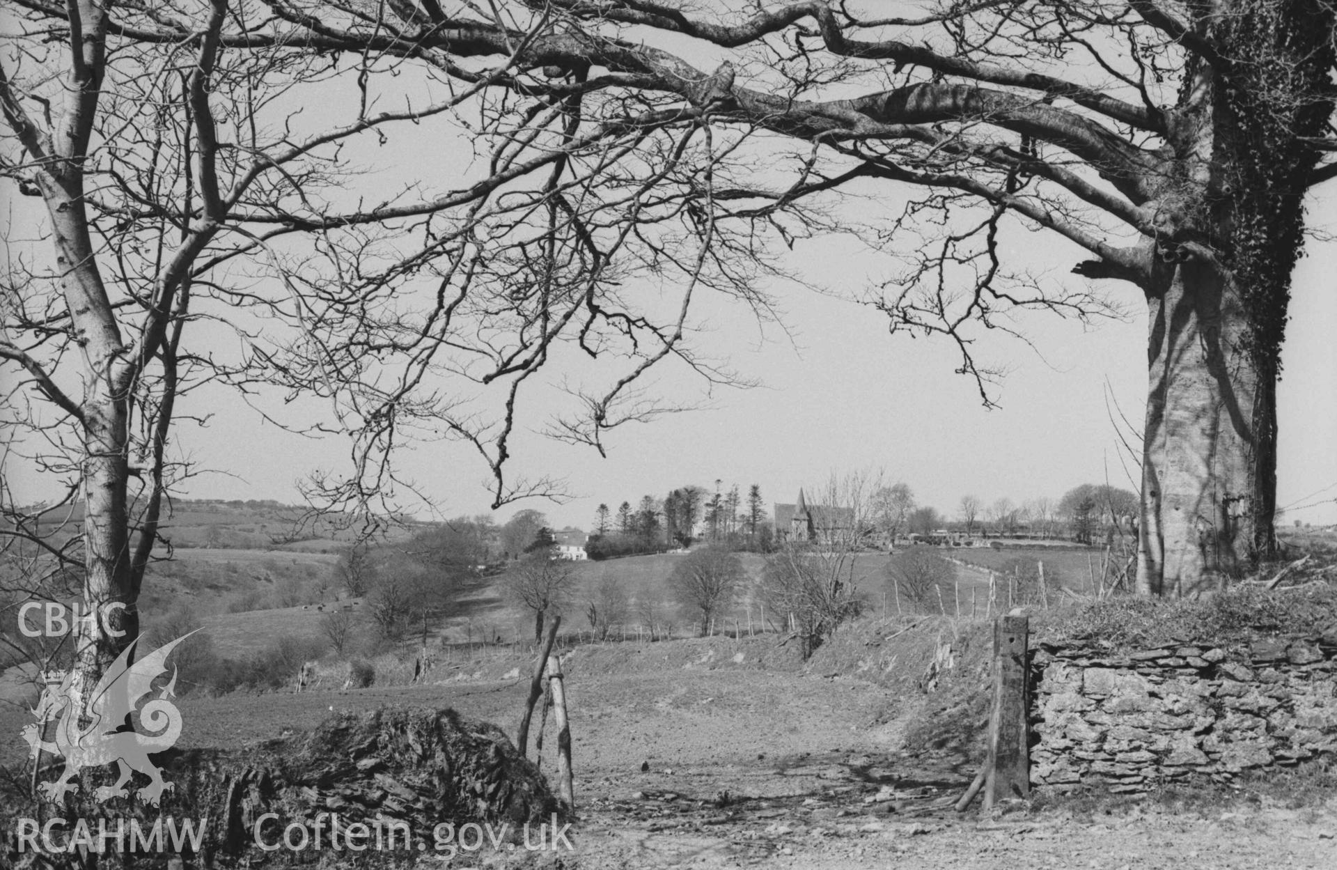 Digital copy of a black and white negative showing Llangynllo church from the lane by Bronwydd farm. Photographed by Arthur Chater on 5 April 1969. Looking north north west from Grid Reference SN 3534 4332.