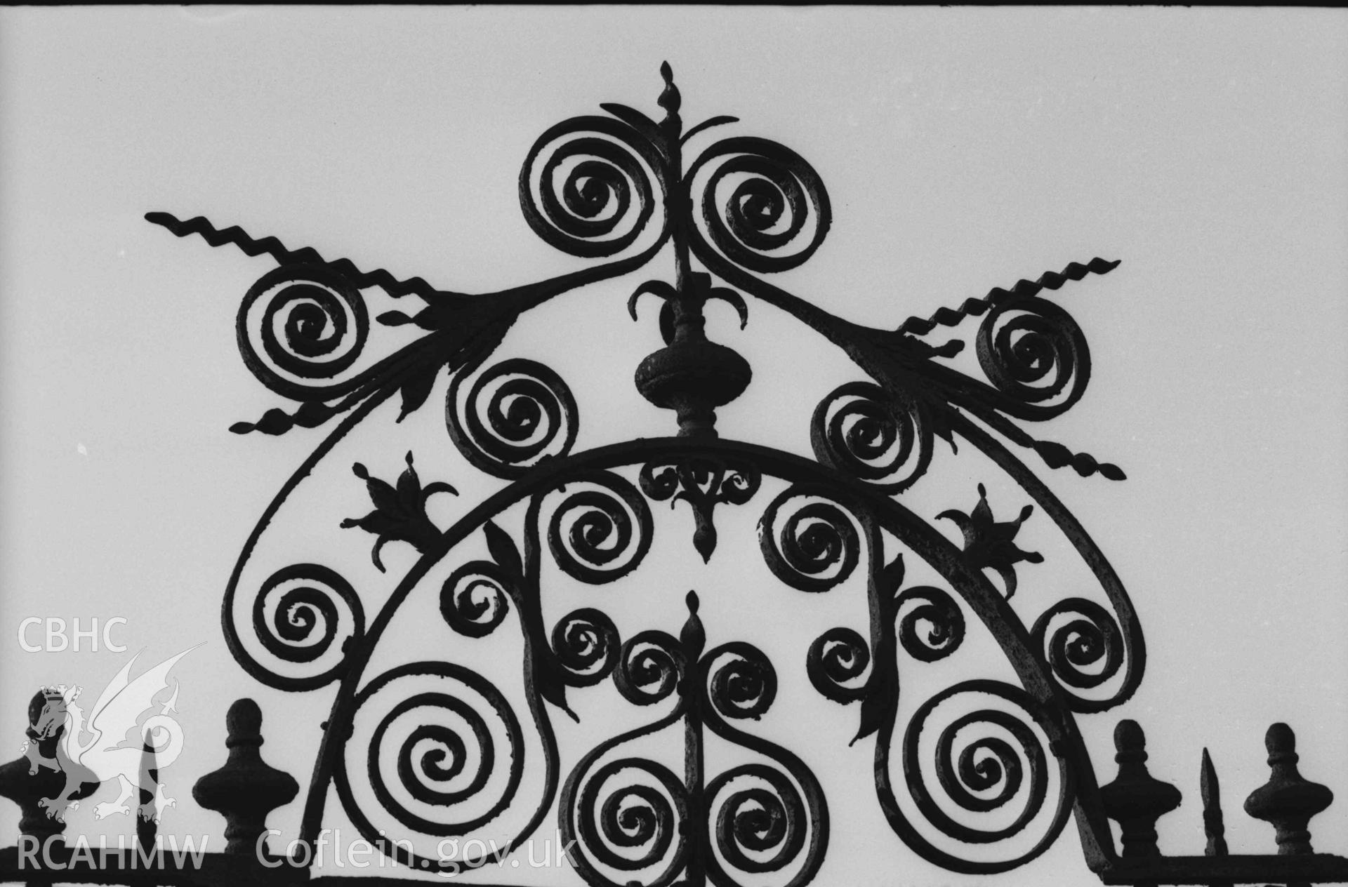 Digital copy of a black and white negative showing tomb of the Rev. Benjamin Evans with wrought ironwork in front of Capel Hawen. Photographed by Arthur Chater on 5 April 1969. Grid Reference SN 3464 4680.