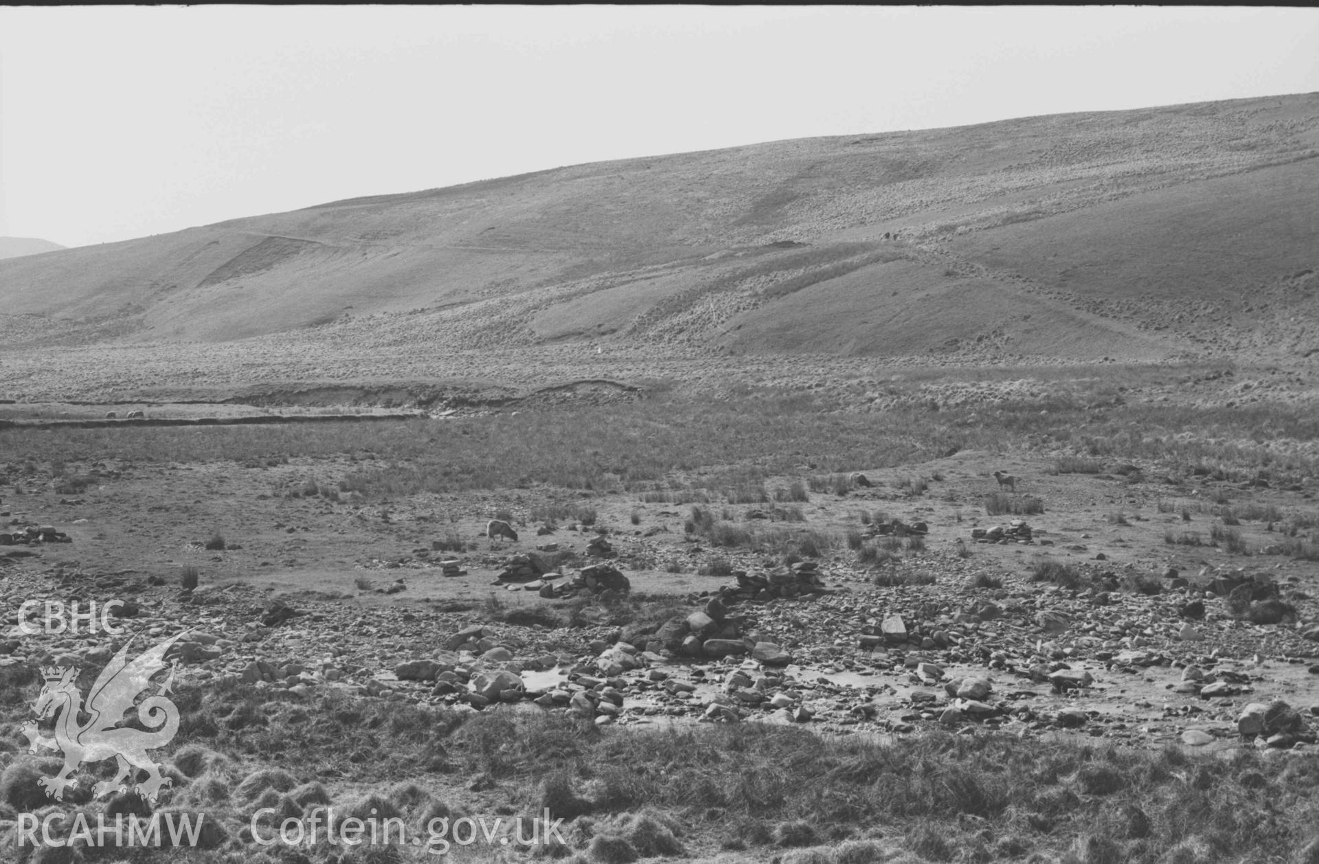 Digital copy of a black and white negative showing view across the Afon Claerwen from just below Rhyd Hengae, showing the old road (right) and the ruins of Hengae. Photographed by Arthur Chater on 8 April 1969. Looking west from Grid Reference SN 8238 6813.