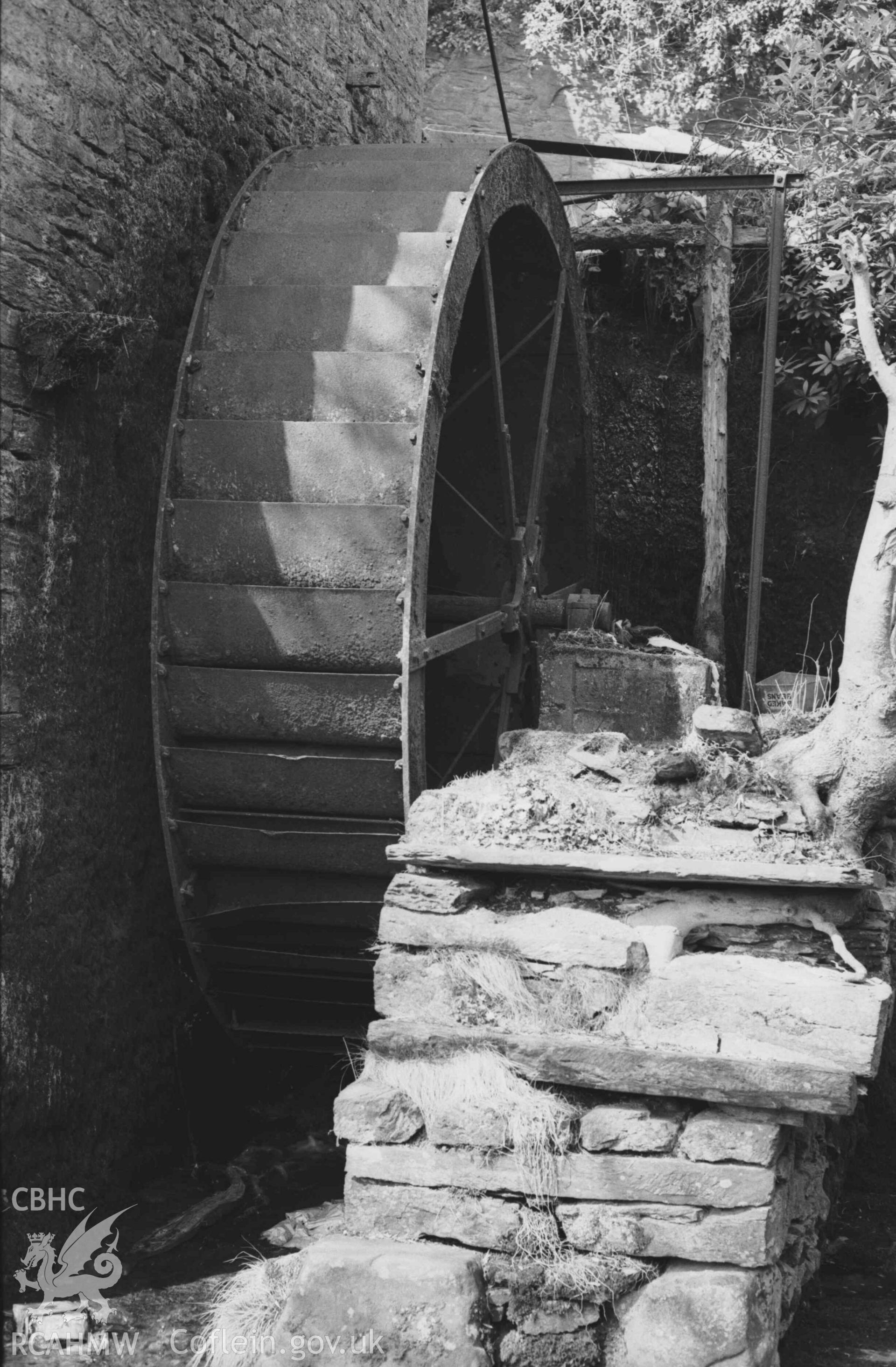 Digital copy of a black and white negative showing iron overshot waterwheel at Felin-Wnda mill. Photographed by Arthur Chater on 7 April 1969. Looking north west from Grid Reference SN 3235 4692.