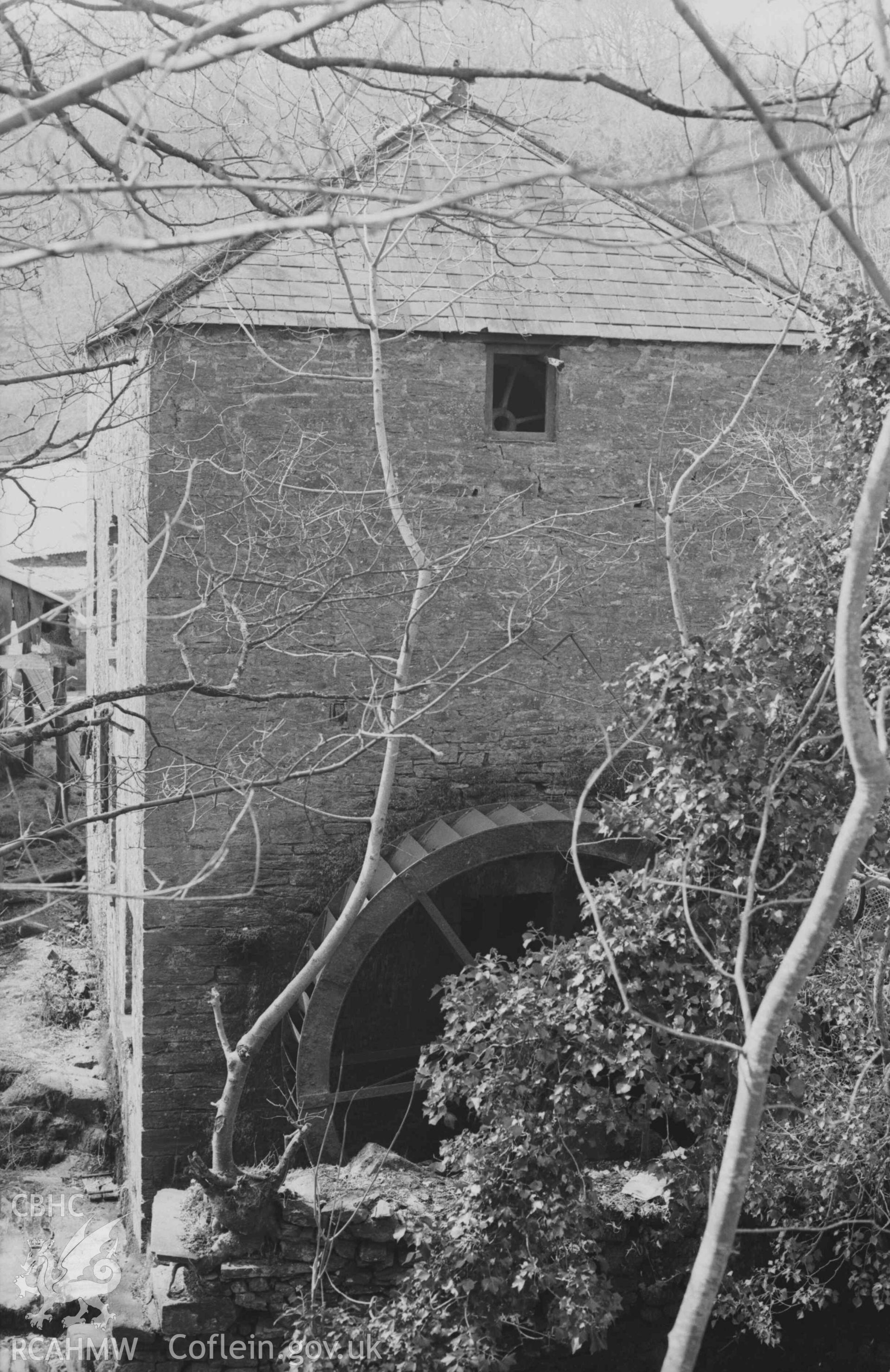 Digital copy of a black and white negative showing Felin-Wnda watermill from across the Afon Ceri. Photographed by Arthur Chater on 7 April 1969. Looking west south west from Grid Reference SN 3236 4692.