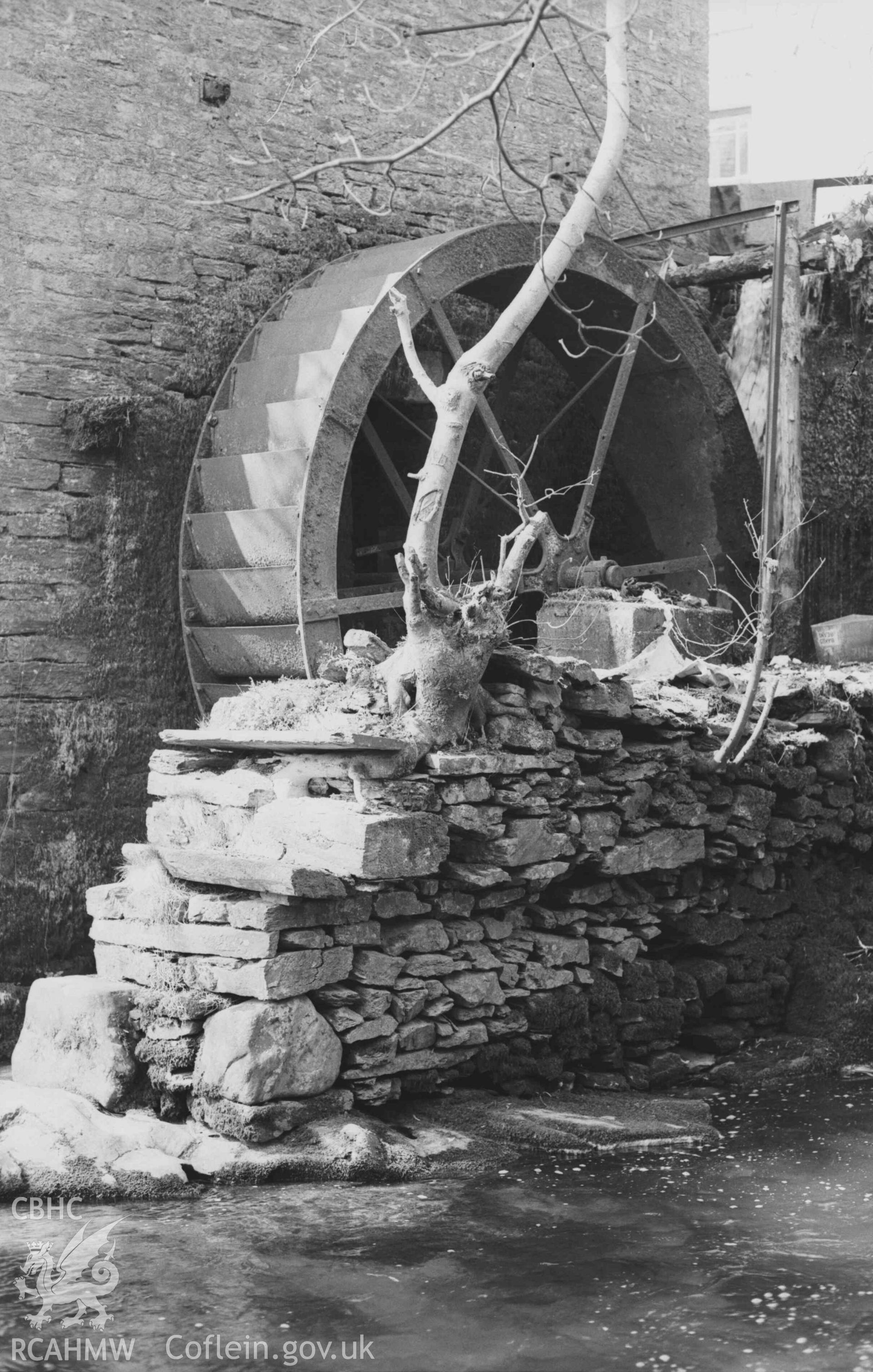 Digital copy of a black and white negative showing iron overshot waterwheel at Felin-Wnda mill. Photographed by Arthur Chater on 7 April 1969. Looking north west from Grid Reference SN 3235 4692.