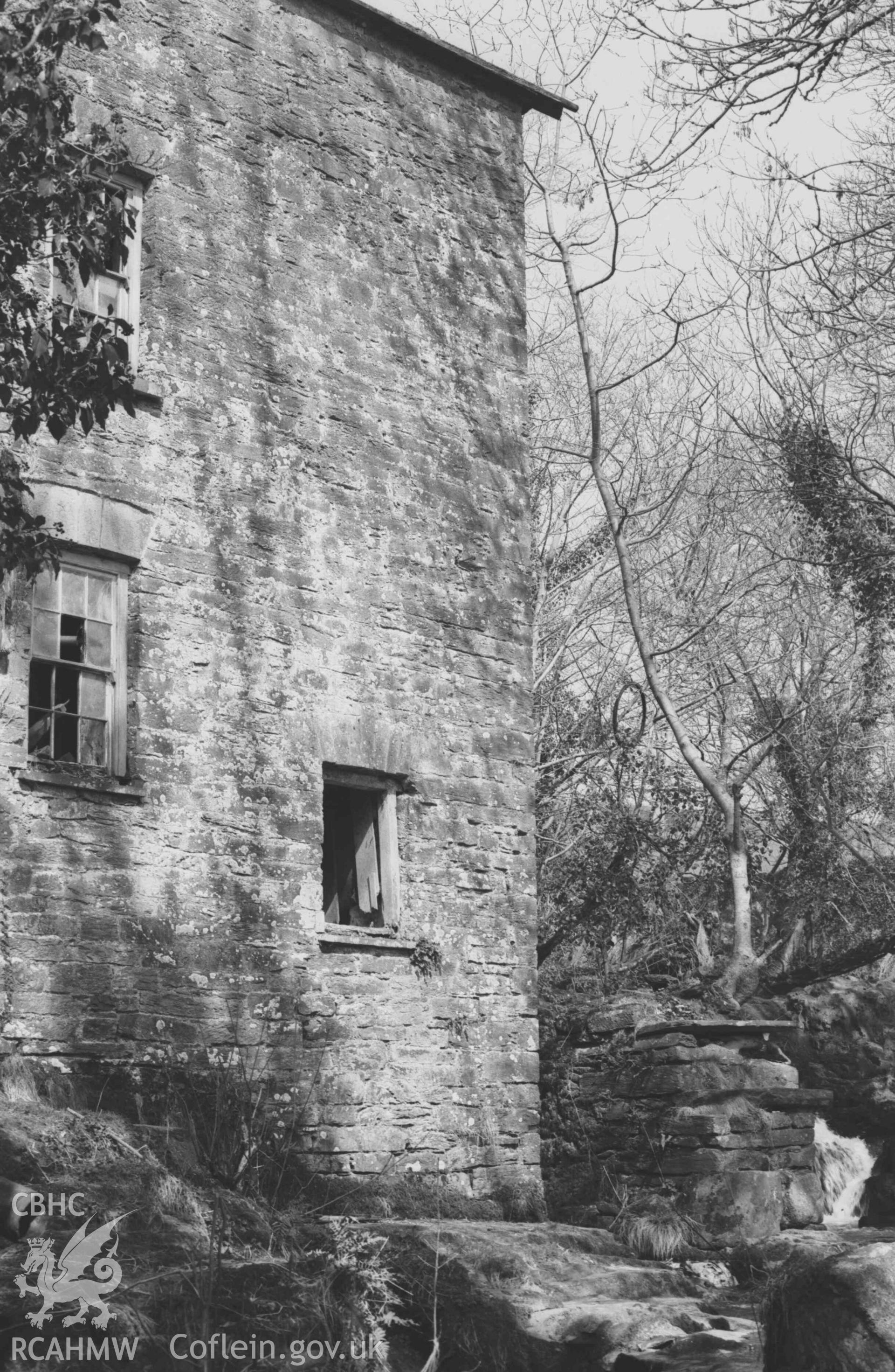 Digital copy of a black and white negative showing corner of Felin-Wnda mill building; wheelpit on the right. Photographed by Arthur Chater on 7 April 1969. Looking north east from Grid Reference SN 3234 4690.