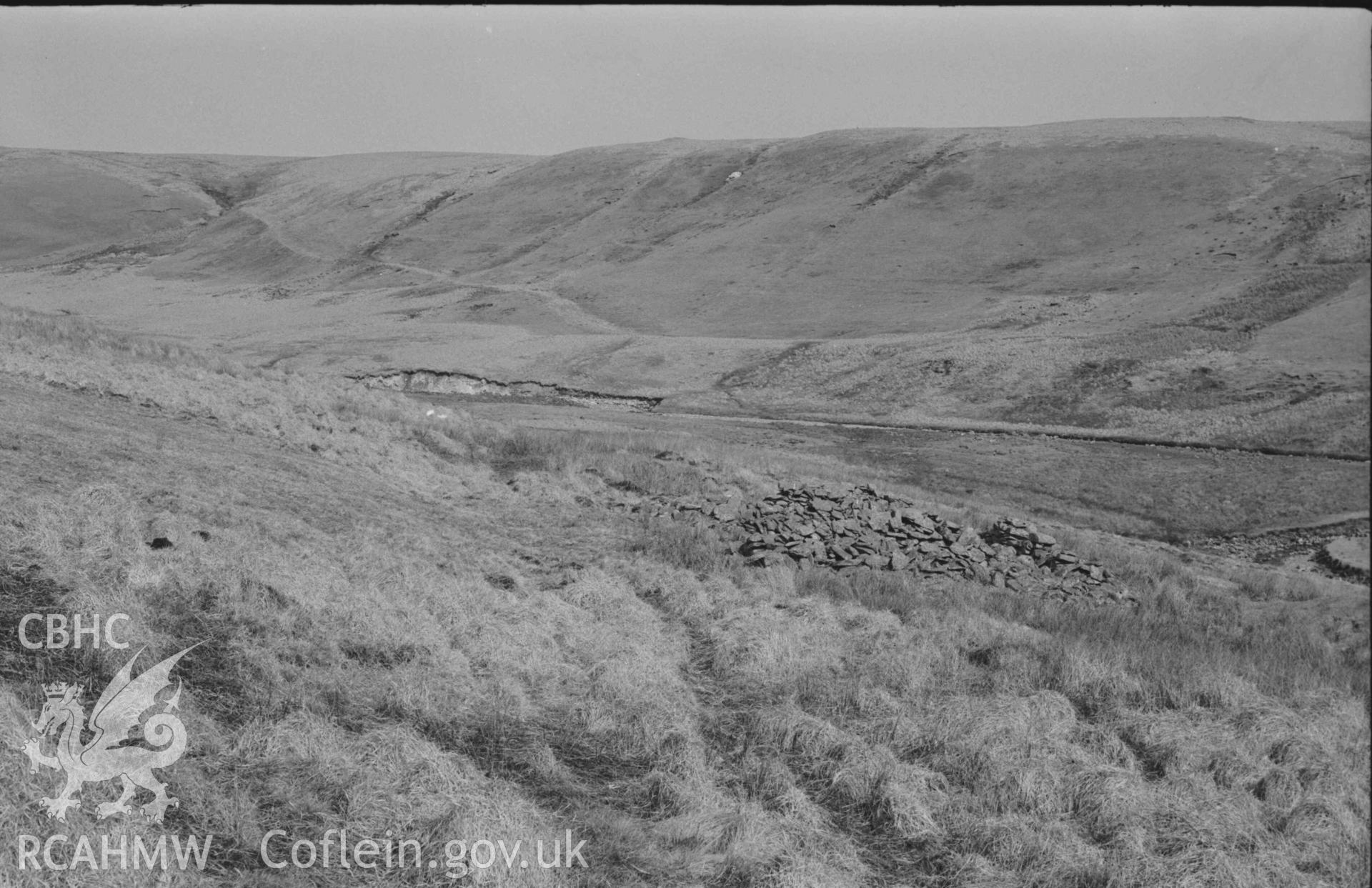 Digital copy of a black and white negative showing view along the old road past the ruin of Hengae (right) to Rhyd Hengae. Photographed by Arthur Chater on 8 April 1969. Looking east north east from Grid Reference SN 8200 6806.