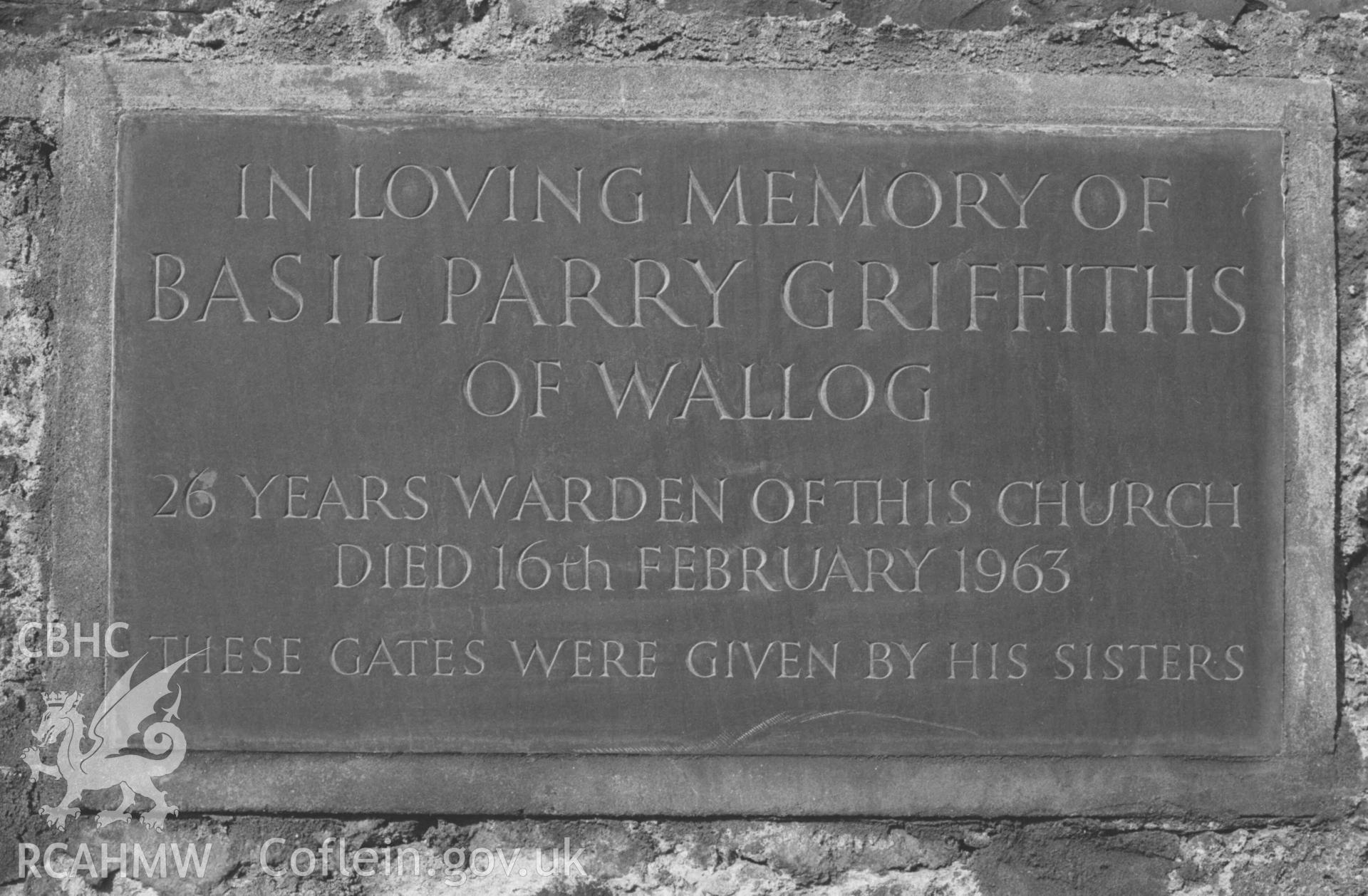 Digital copy of a black and white negative showing inscribed slate by gate at west end of All Saints' Churchyard, Llangorwen. Photographed by Arthur Chater on 12 April 1969. Looking west from Grid Reference SN 6030 8382.