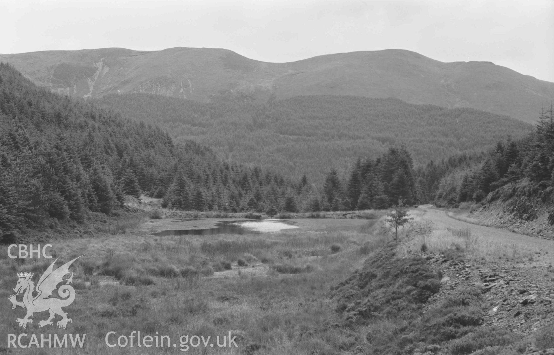 Digital copy of a black and white negative showing mine reservoir 500m north of Cwmergyr chapel. Photographed by Arthur Chater on 25 August 1969. Looking south from Grid Reference SN 7947 8324.