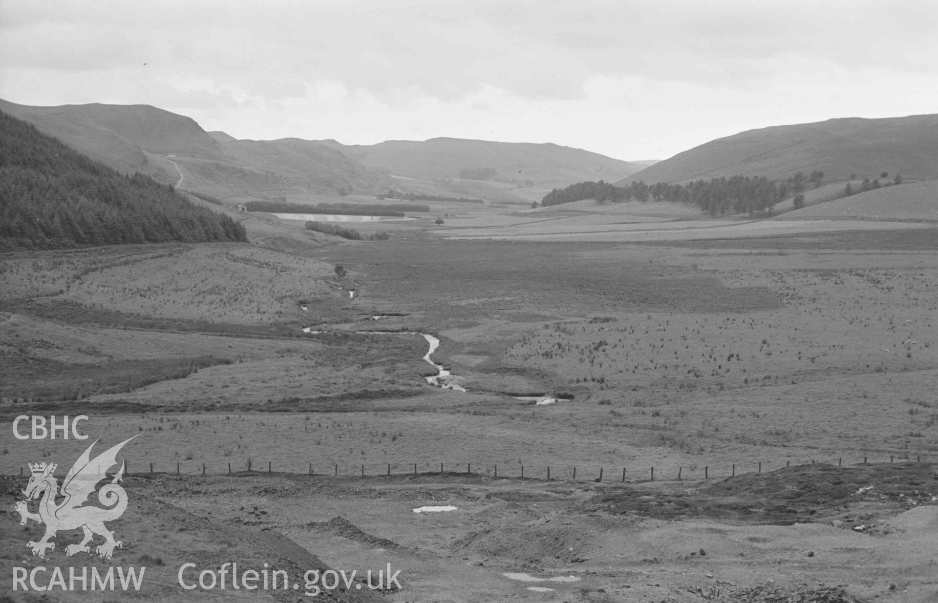 Digital copy of a black and white negative showing view down the Afon Castell from the lead mine, Llys-Arthur in centre; Gelli-Uchaf to the right. (Panorama, photograph 2 of 4). Photographed by Arthur Chater on 25 August 1969. Looking south west from Grid Reference SN 7912 8278.