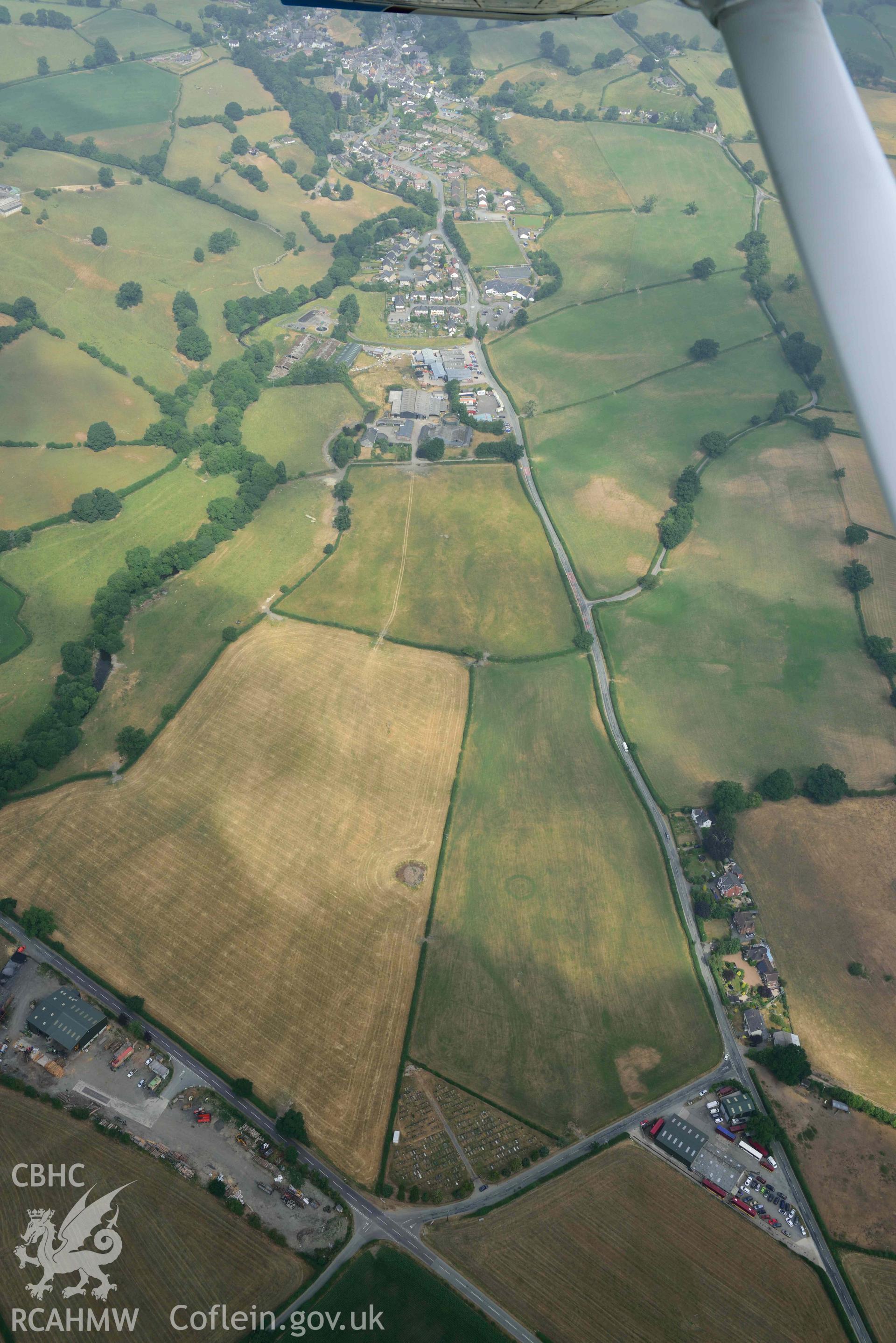 Llanrhaeadr ym Mochnant cropmarks. Oblique aerial photograph taken during the Royal Commission’s programme of archaeological aerial reconnaissance by Toby Driver on 10 July 2018.