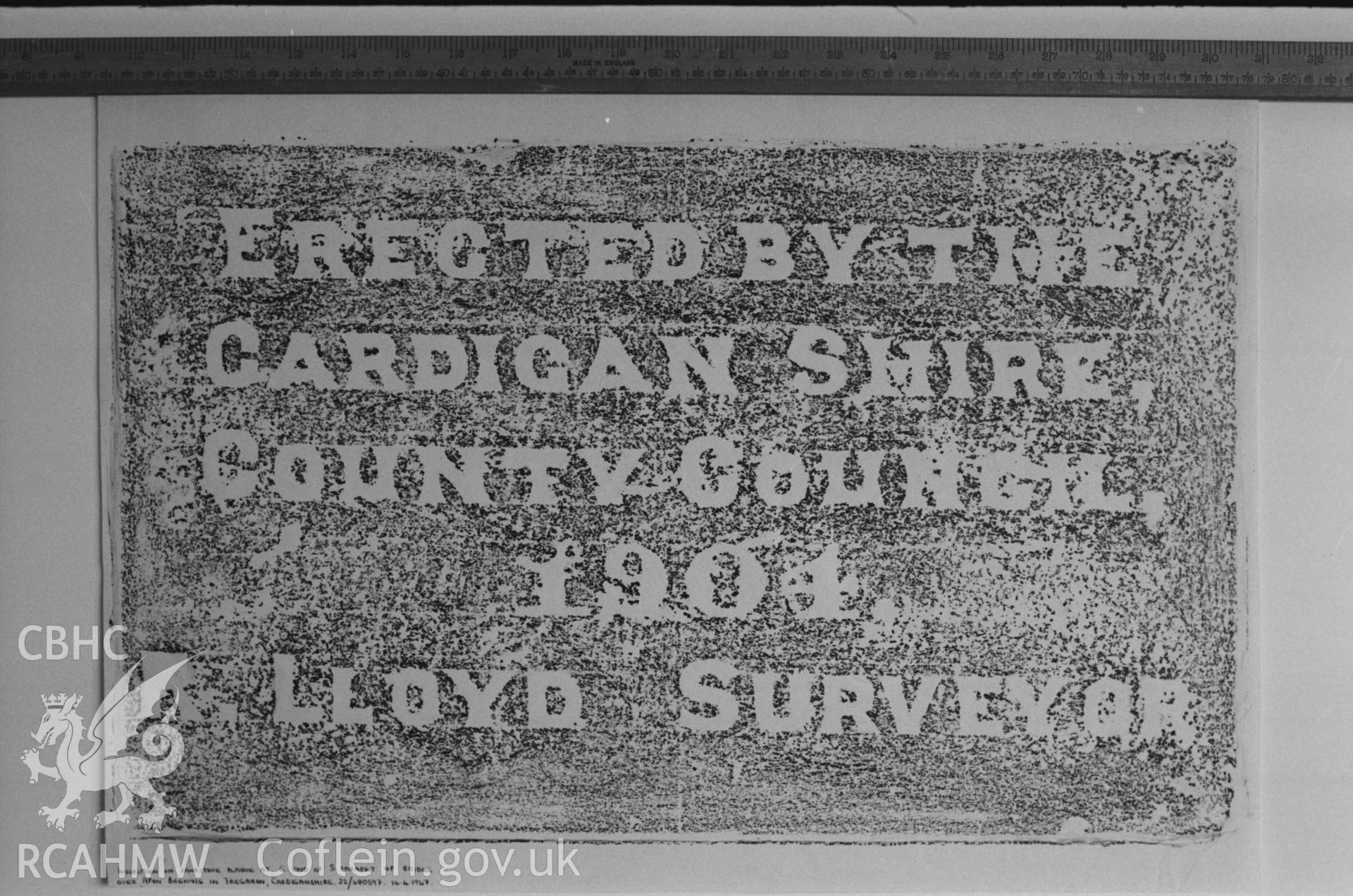 Digital copy of a black and white negative showing rubbing of plaque on Pont Tregaron over Afon Brennig. Produced by Arthur Chater on 26 August 1969.