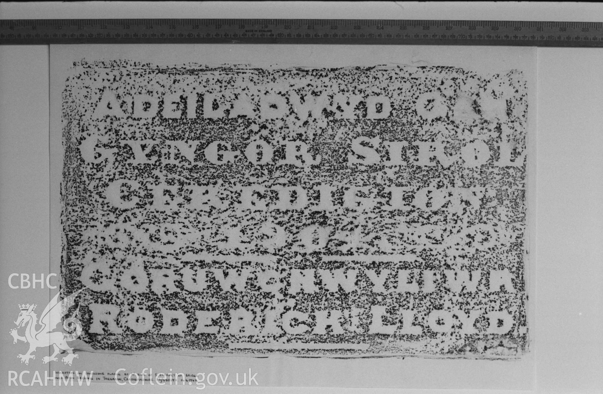 Digital copy of a black and white negative showing rubbing of plaque on Pont Tregaron over Afon Brennig. Produced by Arthur Chater on 26 August 1969.