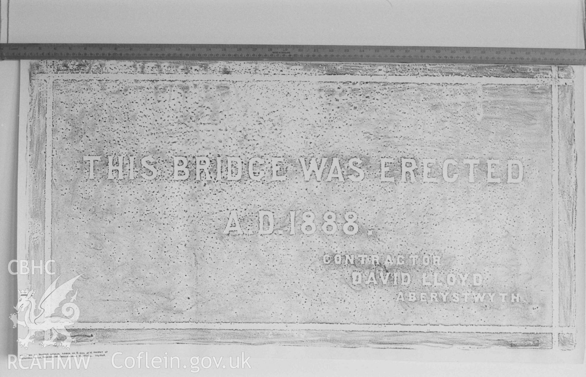 Digital copy of a black and white negative showing inscription on polished granite plaque on the east side of the west parapet of Trefechan Bridge, Aberystwyth. Produced by Arthur Chater on 26 August 1969.