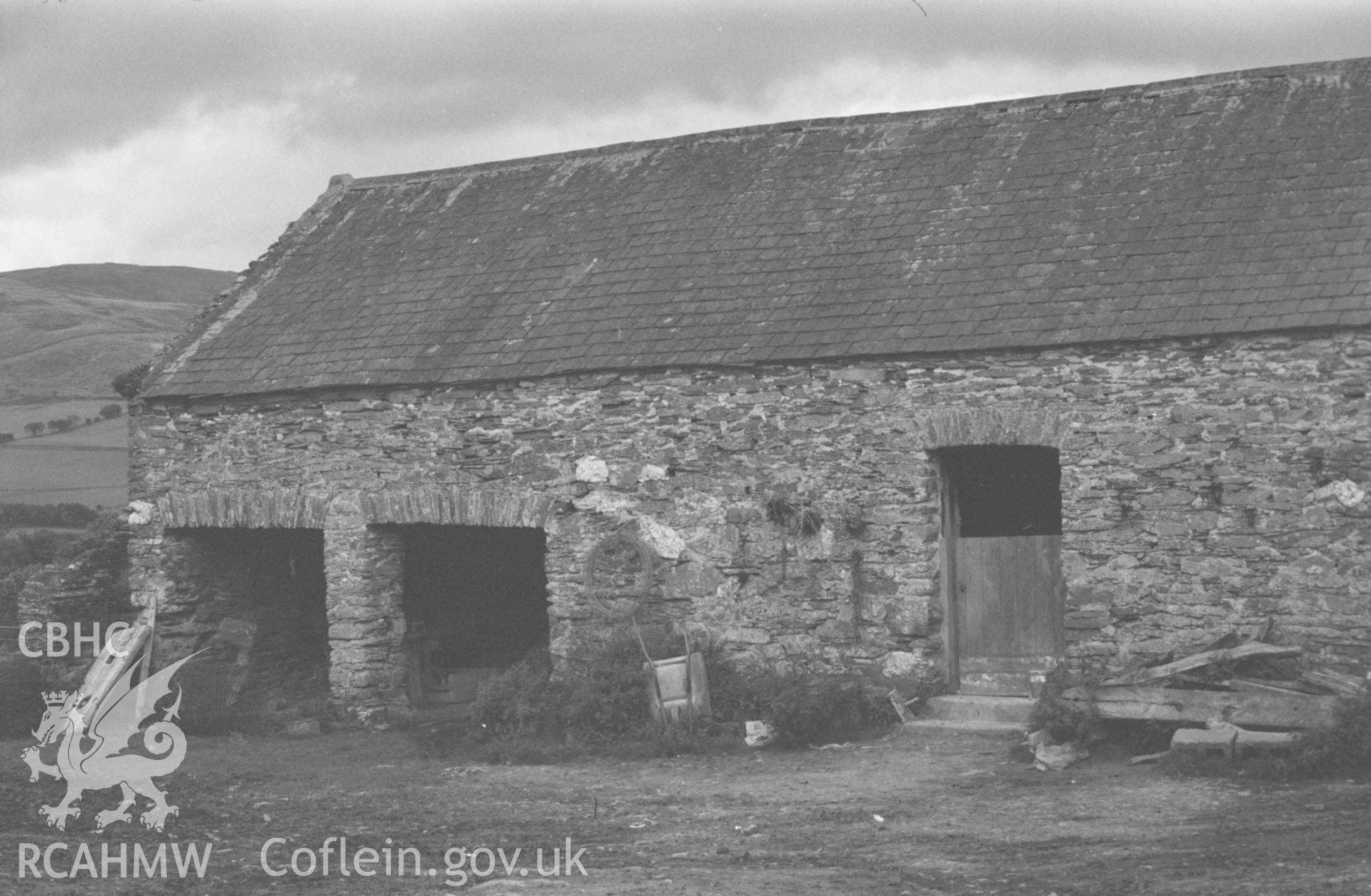 Digital copy of a black and white negative showing outbuildings at Gwar-Cwm-Isaf. Photographed by Arthur Chater on 27 August 1969, looking north east from Grid Reference SN 6677 9160.