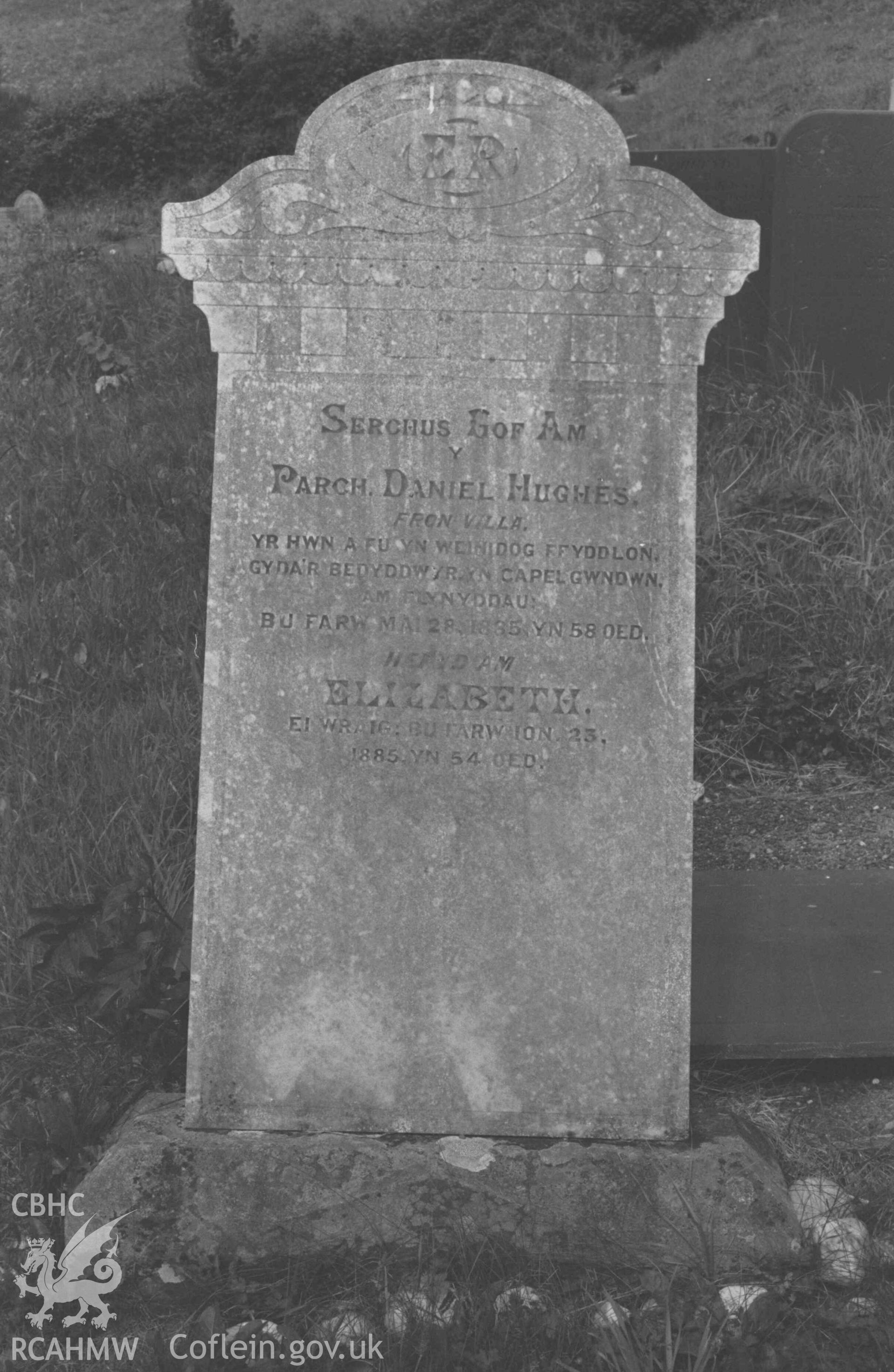 Digital copy of a black and white negative showing tombstone of Daniel Hughes (minister of Capel Gwndwn) at Capel Llwyndafydd graveyard. Photographed by Arthur Chater on 28 August 1969, looking north west from Grid Reference SN 3703 5558.