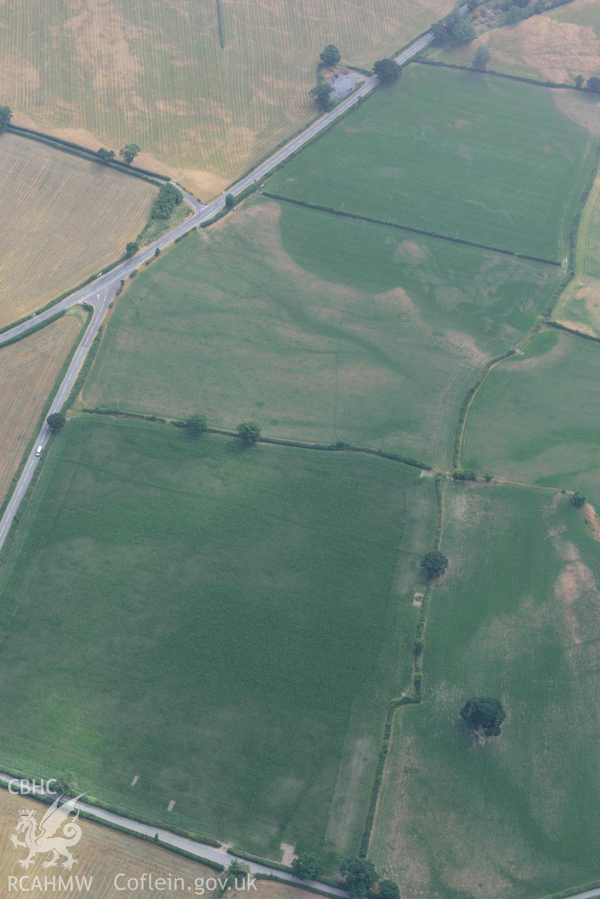 Maes Mochnant mound and cropmarks. Oblique aerial photograph taken during the Royal Commission’s programme of archaeological aerial reconnaissance by Toby Driver on 10 July 2018.
