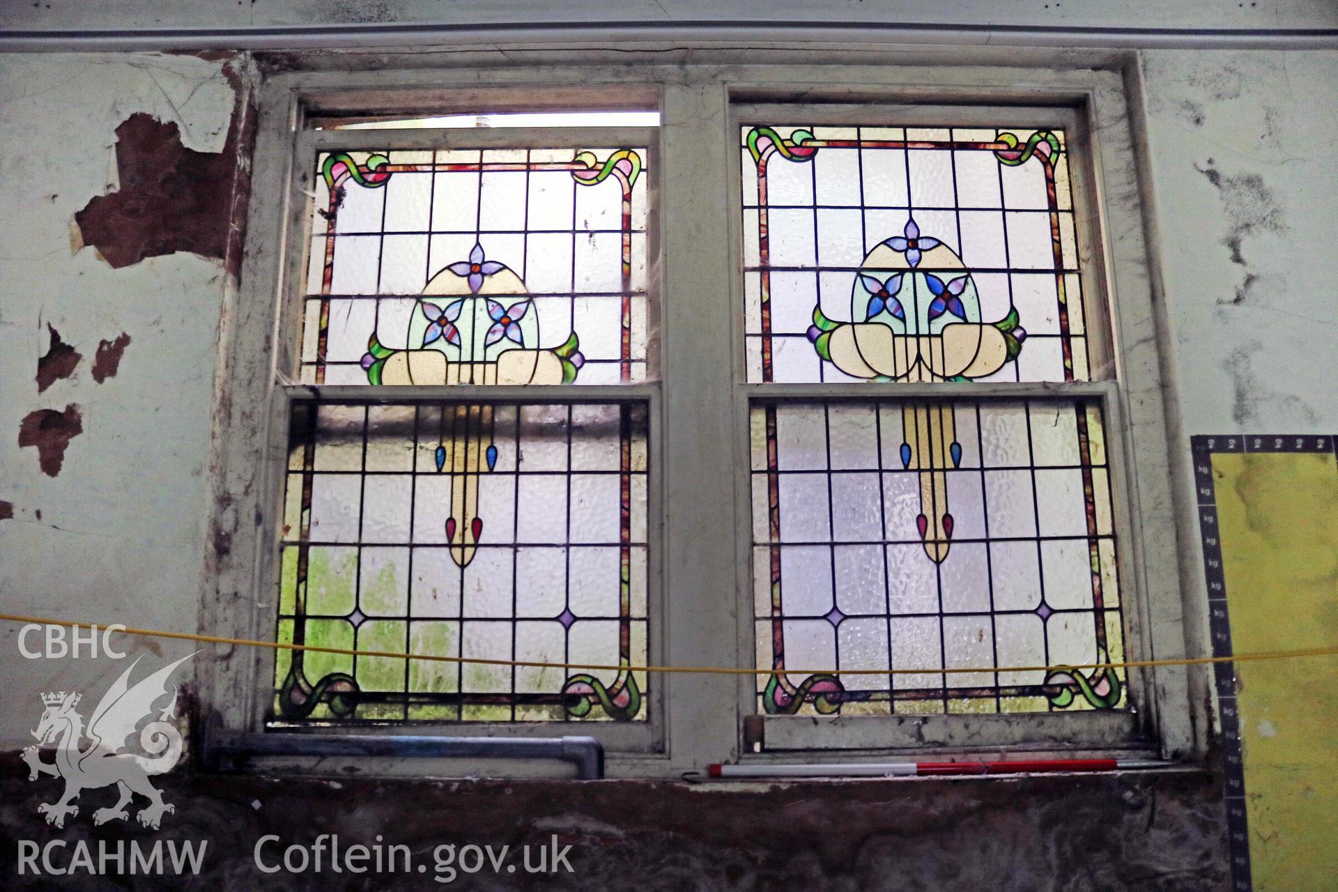 Photograph showing chapel Sunday School stained glass window, from a Level 4 Historic Building Record of the former Howells Department Store, Cardiff. Conducted as a part of listed building consent by Purcell Architecture in 2024.