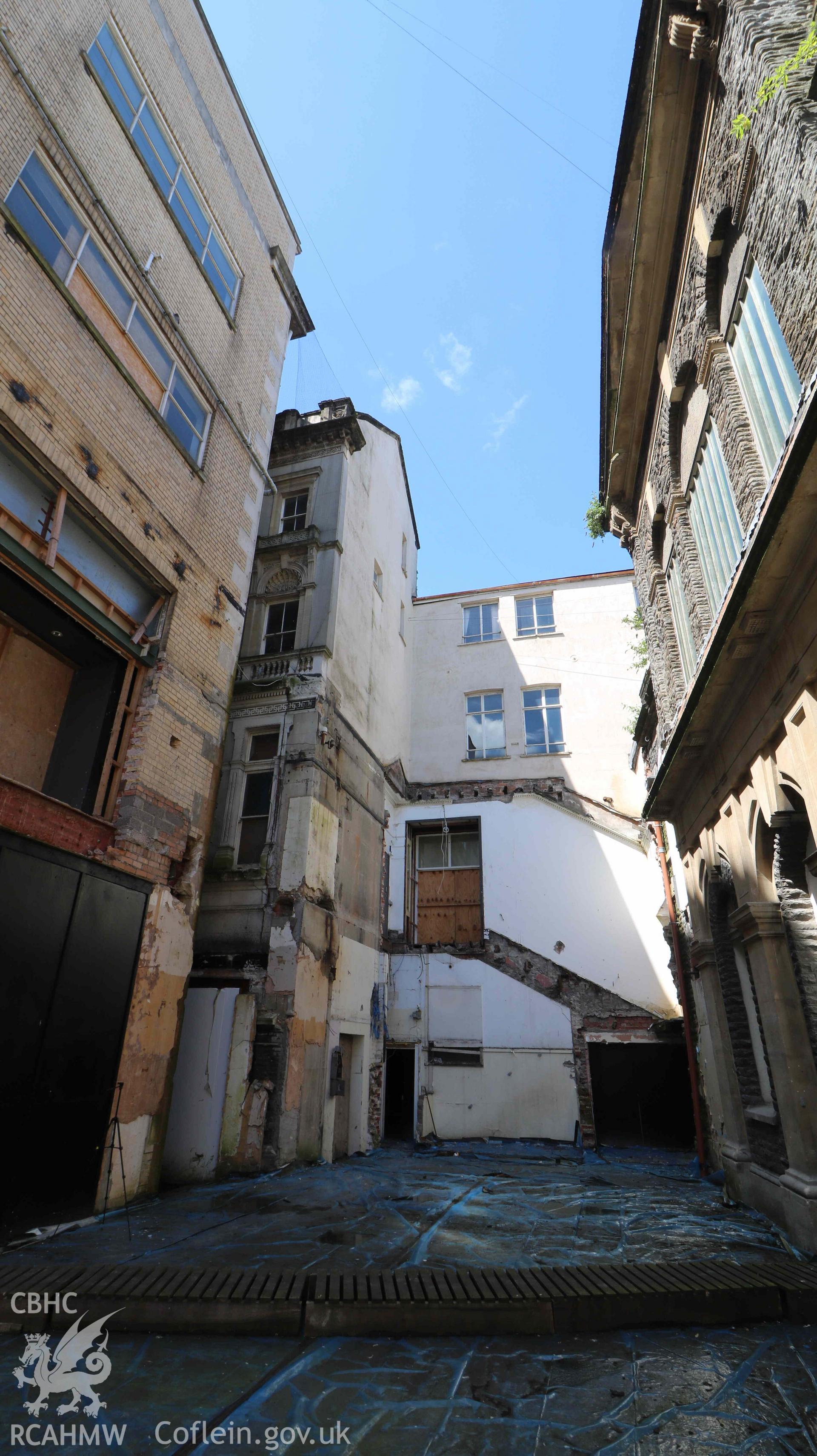 Photograph showing external space - previously demolished modern infill, from a Level 4 Historic Building Record of the former Howells Department Store, Cardiff. Conducted as a part of listed building consent by Purcell Architecture in 2024.