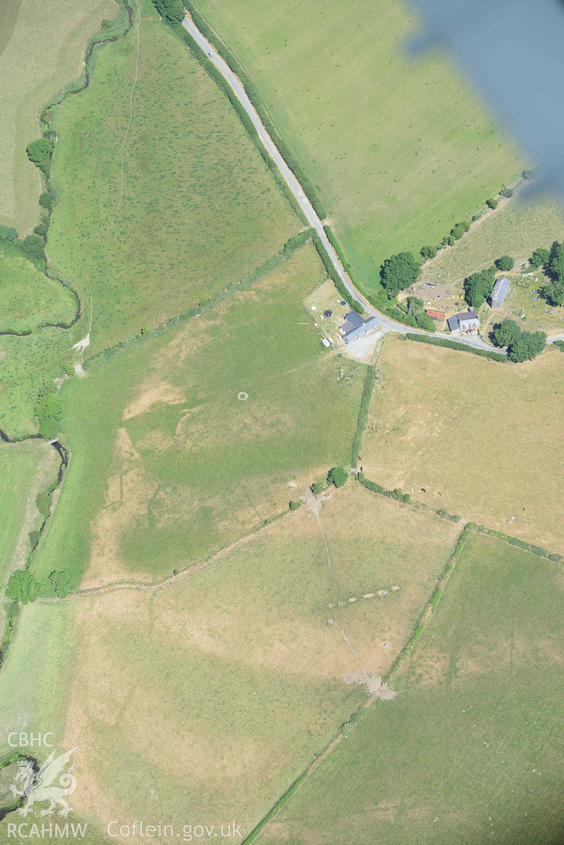 St Gwynnins Church and Tyn Llan square enclosure. Oblique aerial photograph taken during the Royal Commission’s programme of archaeological aerial reconnaissance by Toby Driver on 10 July 2018.