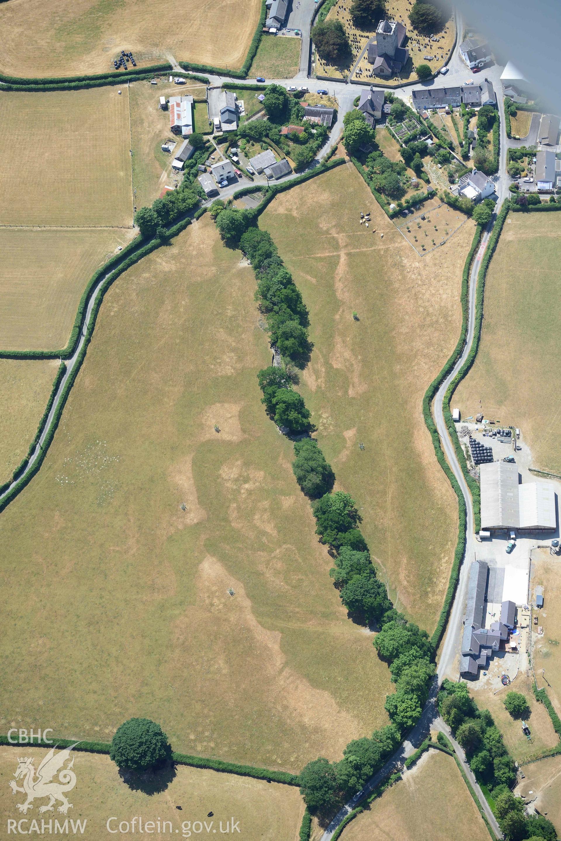 Cropmark in field immediately adjacent to Lisburne House, Llanfihangel y Creuddyn. Oblique aerial photograph taken during the Royal Commission’s programme of archaeological aerial reconnaissance by Toby Driver on 10 July 2018.