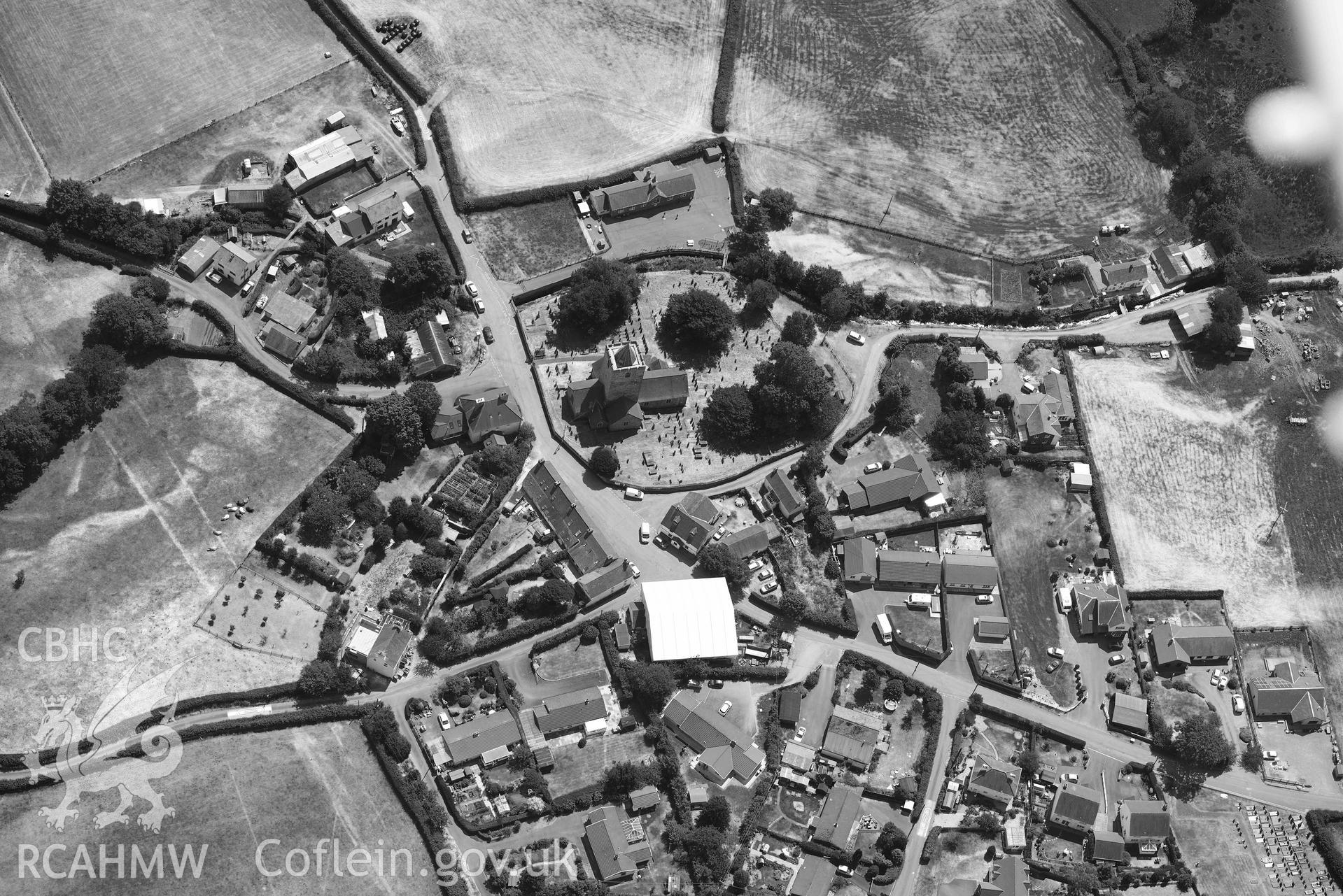 St Michael's Church, Llanfihangel y Creuddyn. Oblique black and white aerial photograph taken during the Royal Commission’s programme of archaeological aerial reconnaissance by Toby Driver on 10 July 2018.