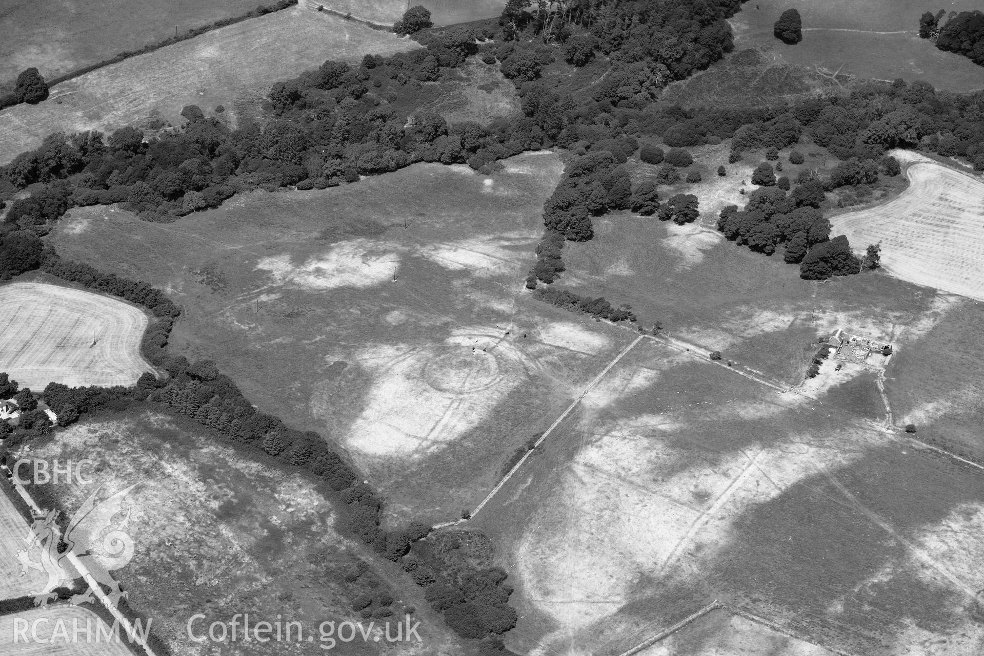 Circular cropmark enclosure on site of Capel Gwerthyr chapel. Oblique black and white aerial photograph taken during the Royal Commission’s programme of archaeological aerial reconnaissance by Toby Driver on 10 July 2018.