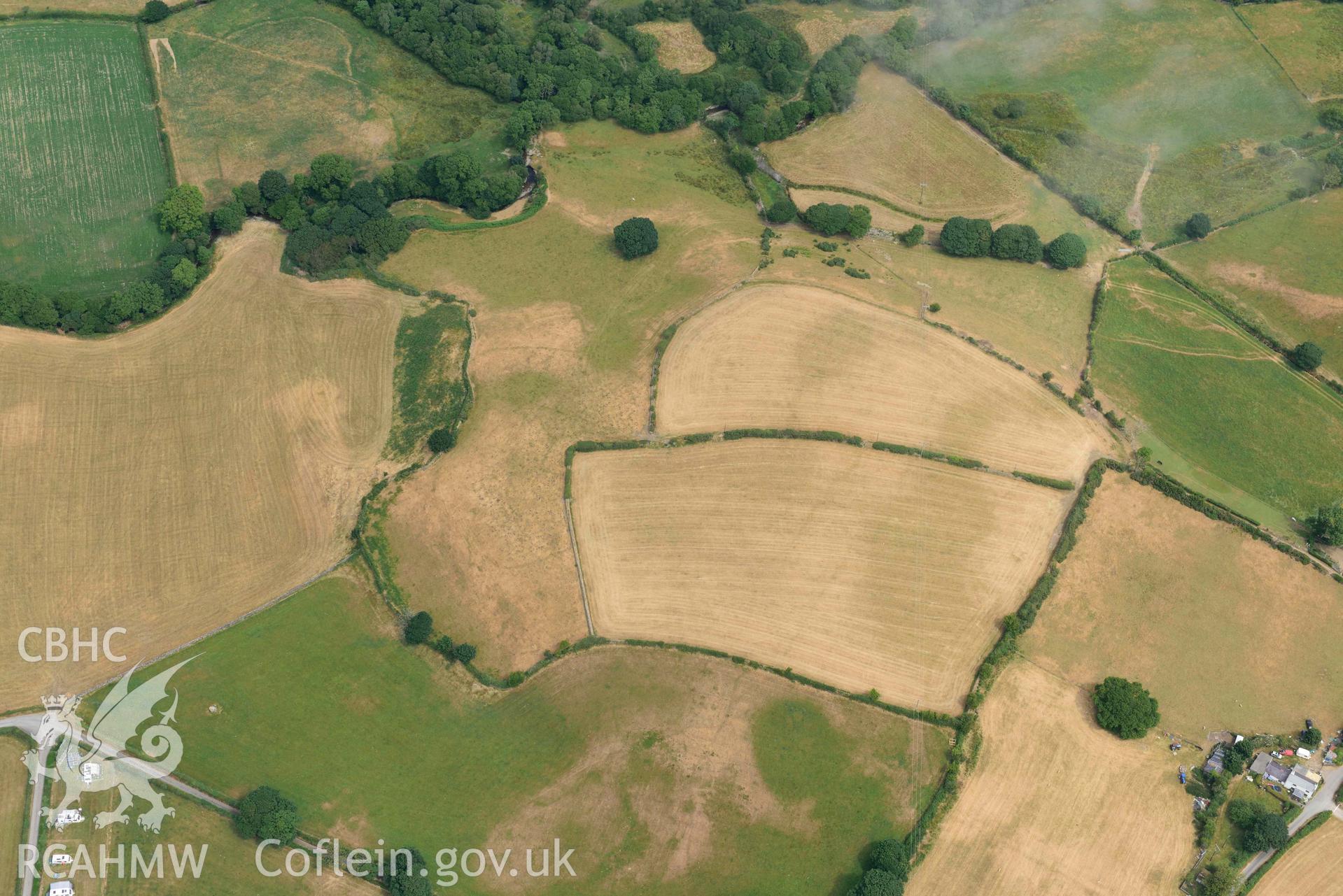 Penarth burial chamber and cropmark east of Penarth burial chamber. Oblique aerial photograph taken during the Royal Commission’s programme of archaeological aerial reconnaissance by Toby Driver on 10 July 2018.