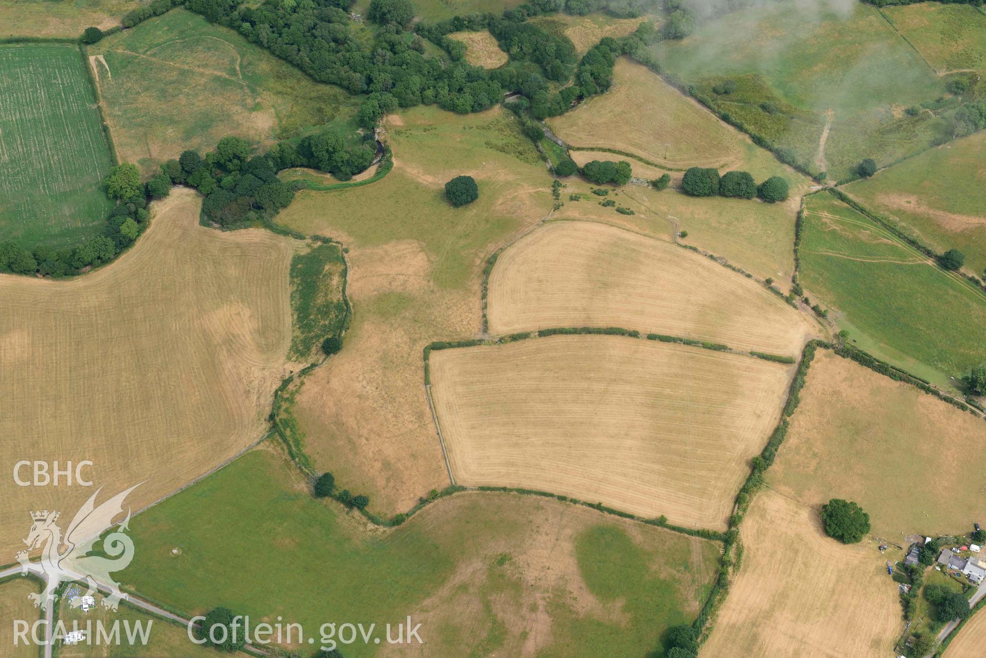 Penarth burial chamber and cropmark east of Penarth burial chamber. Oblique aerial photograph taken during the Royal Commission’s programme of archaeological aerial reconnaissance by Toby Driver on 10 July 2018.