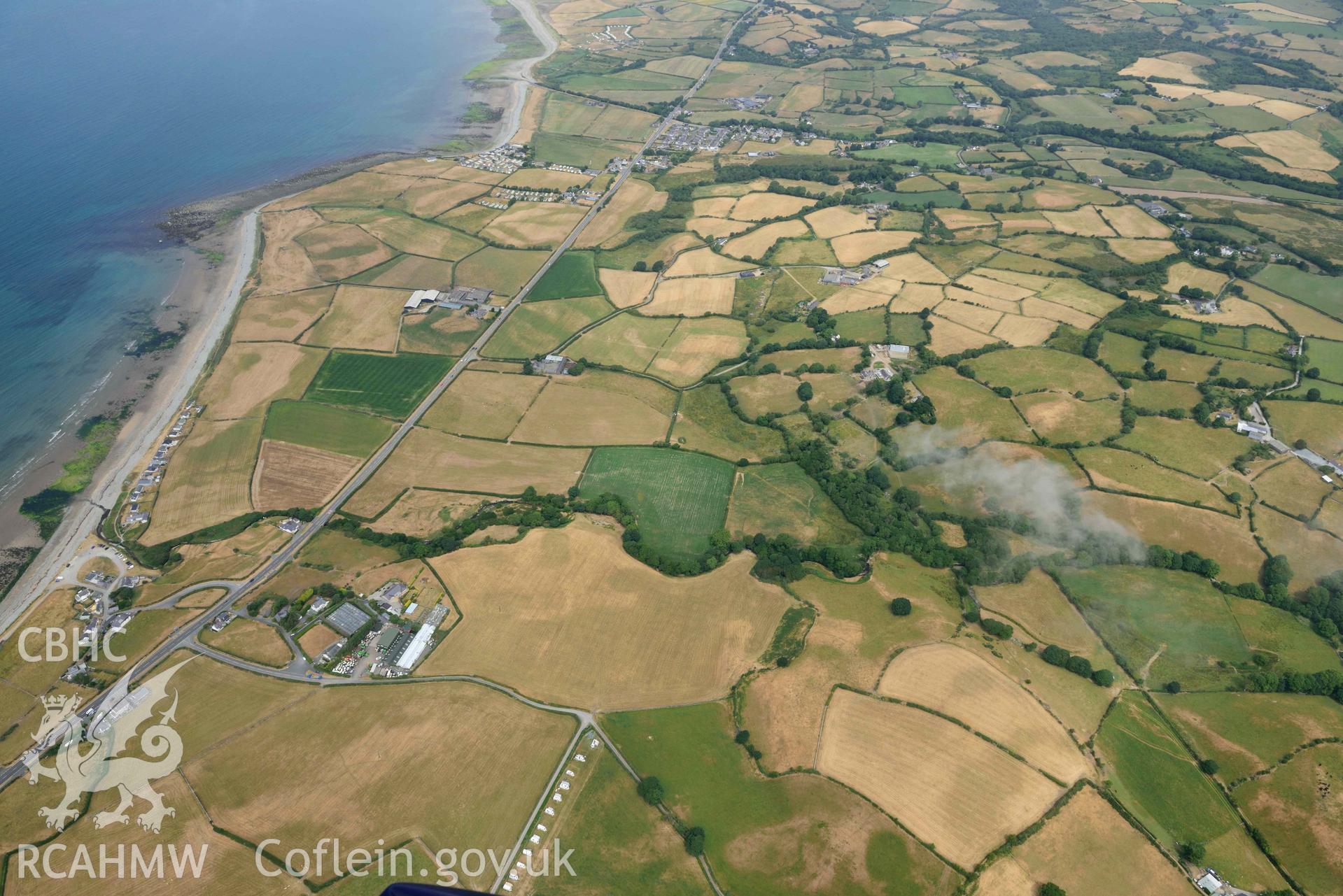 Penarth burial chamber and cropmark east of Penarth burial chamber. Oblique aerial photograph taken during the Royal Commission’s programme of archaeological aerial reconnaissance by Toby Driver on 10 July 2018.