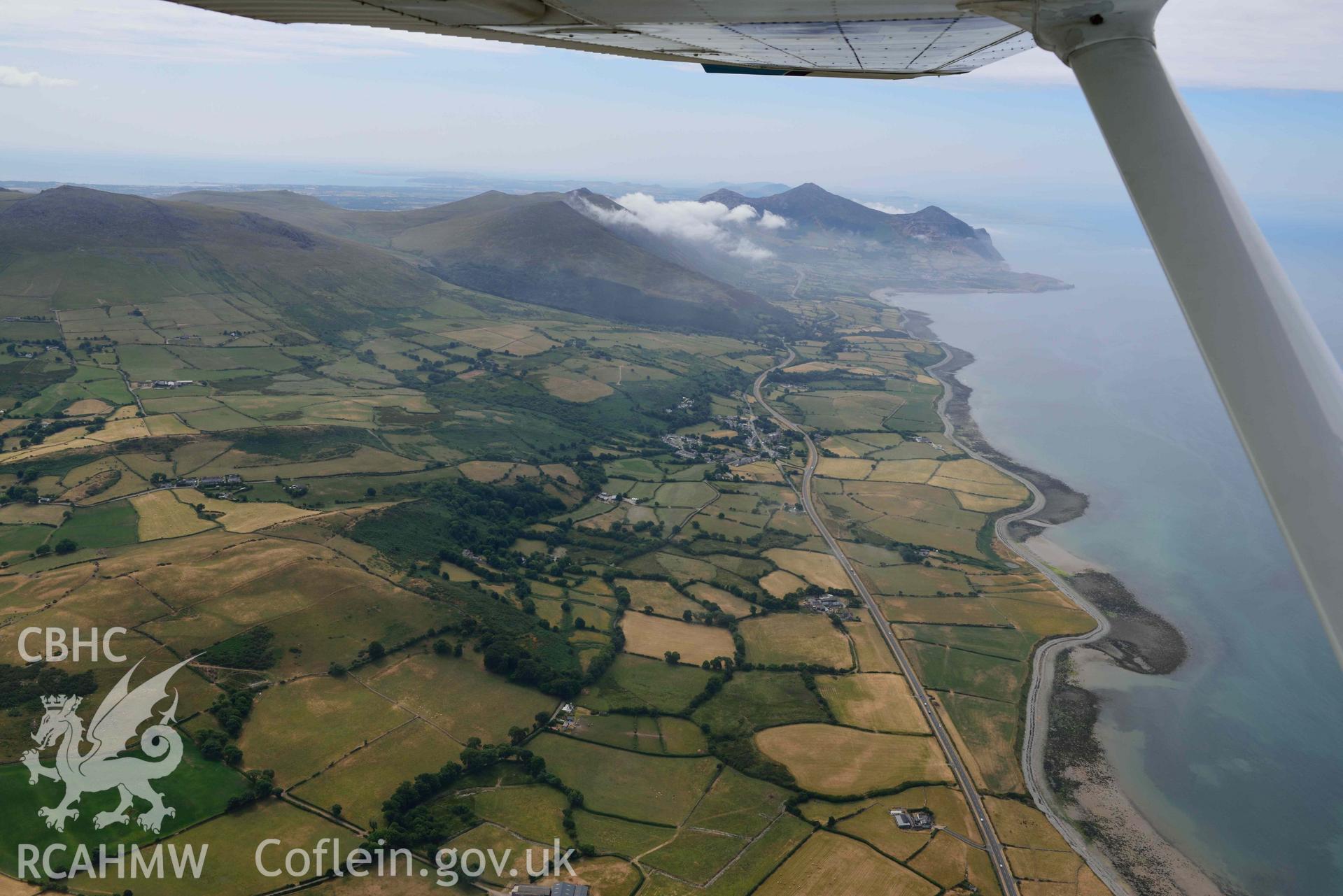 Clynnog Fawr village and surrounding landscape. Oblique aerial photograph taken during the Royal Commission’s programme of archaeological aerial reconnaissance by Toby Driver on 10 July 2018.