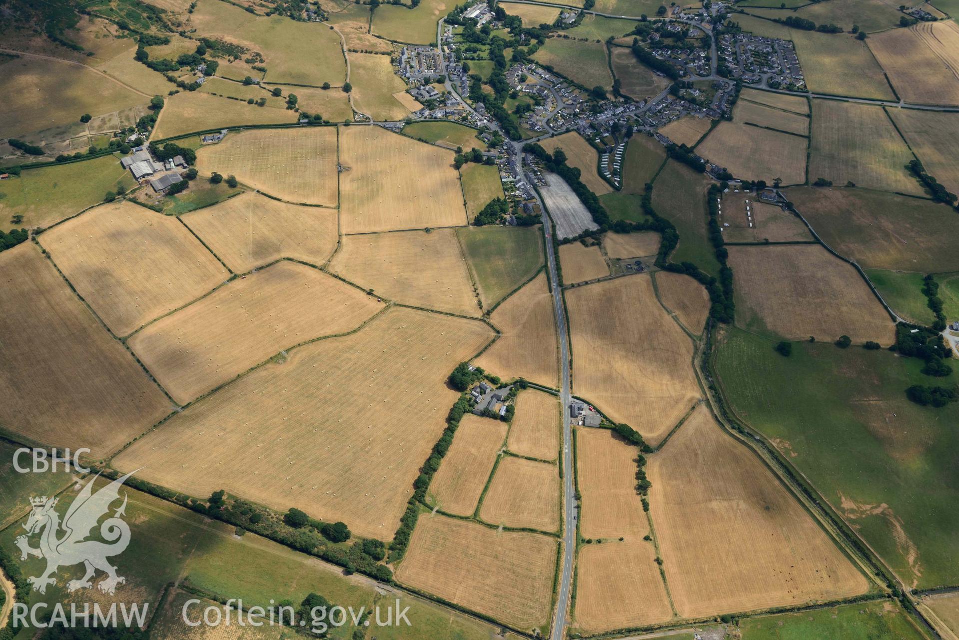 Bryncrug cropmark complex, south-west area, and enclosures to the est of Gwyddelfynydd. Oblique aerial photograph taken during the Royal Commission’s programme of archaeological aerial reconnaissance by Toby Driver on 10 July 2018.