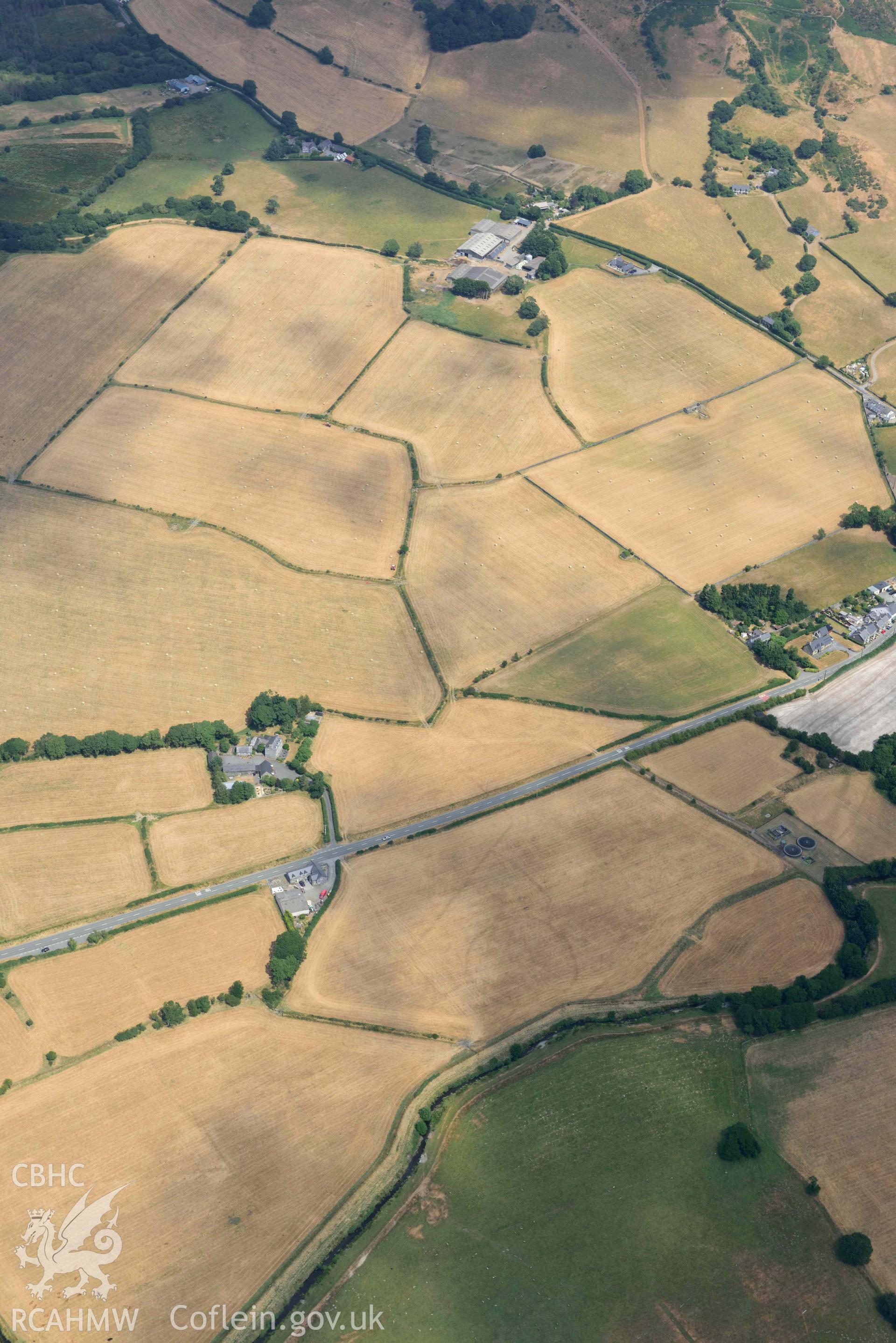 Bryncrug cropmark complex, south-west area, and enclosures to the est of Gwyddelfynydd. Oblique aerial photograph taken during the Royal Commission’s programme of archaeological aerial reconnaissance by Toby Driver on 10 July 2018.