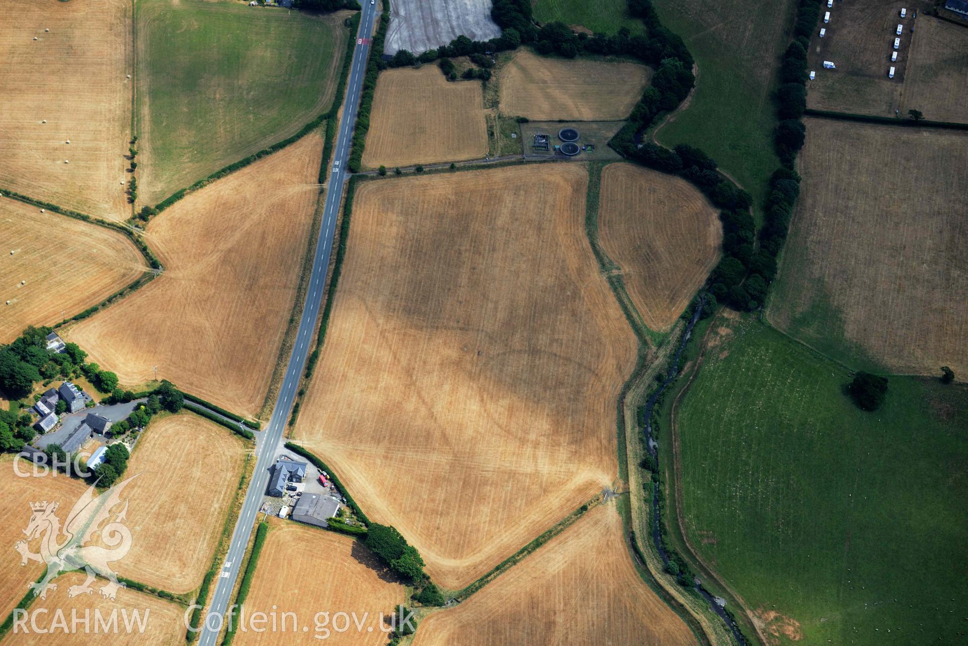 Bryncrug cropmark complex, south-west area. Adjusted oblique aerial photograph taken during the Royal Commission’s programme of archaeological aerial reconnaissance by Toby Driver on 10 July 2018.