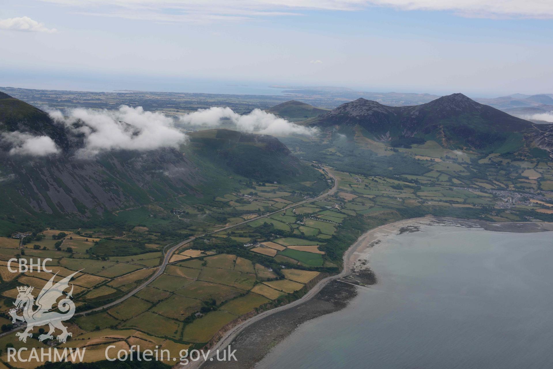 Trefor village, Tre'r Ceiri hillfort and the surrounding landscape. Oblique aerial photograph taken during the Royal Commission’s programme of archaeological aerial reconnaissance by Toby Driver on 10 July 2018.