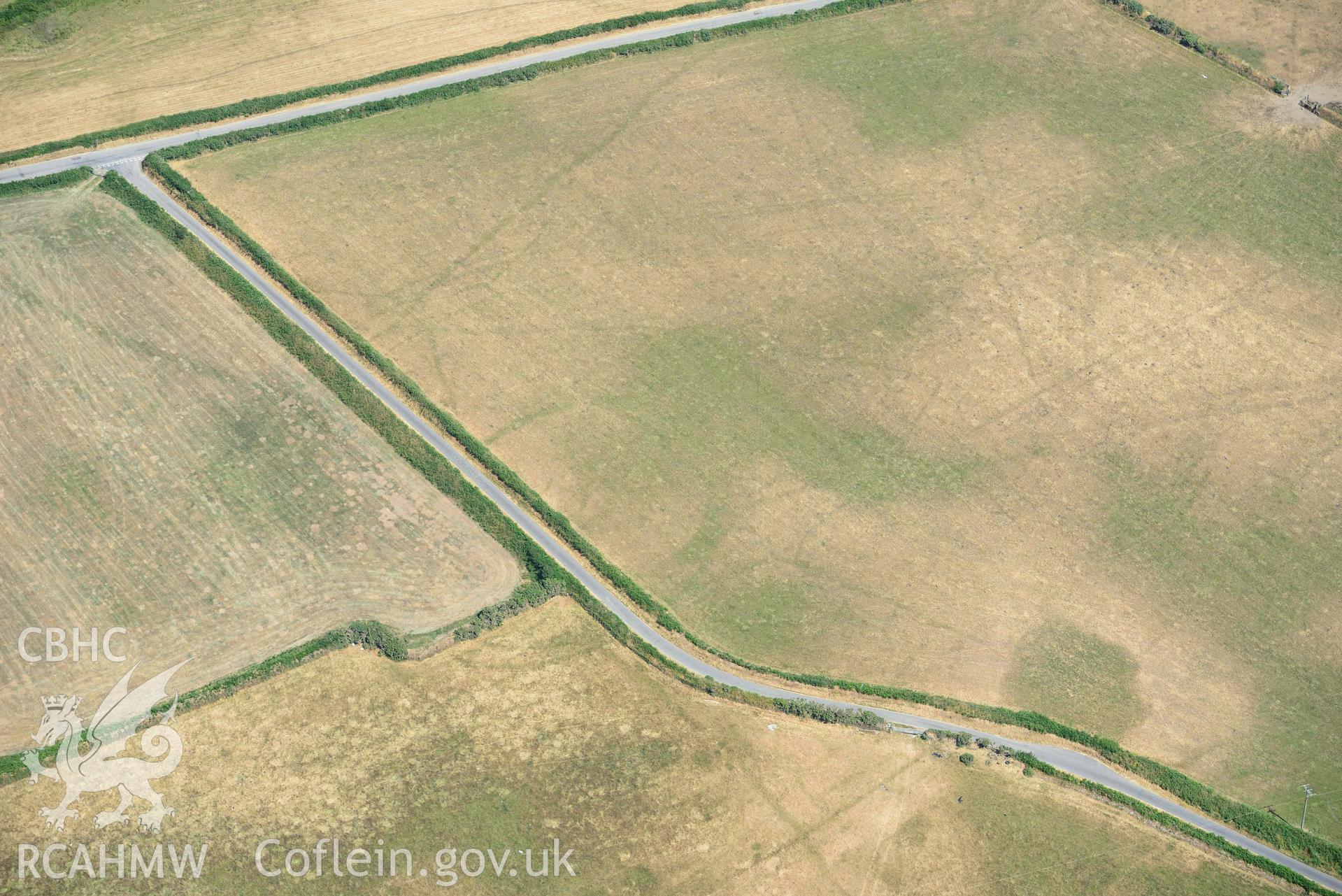 Detailed view of Baroch fawr cropmark enclosure. Oblique black and white aerial photograph taken during the Royal Commission’s programme of archaeological aerial reconnaissance by Toby Driver on 10 July 2018.