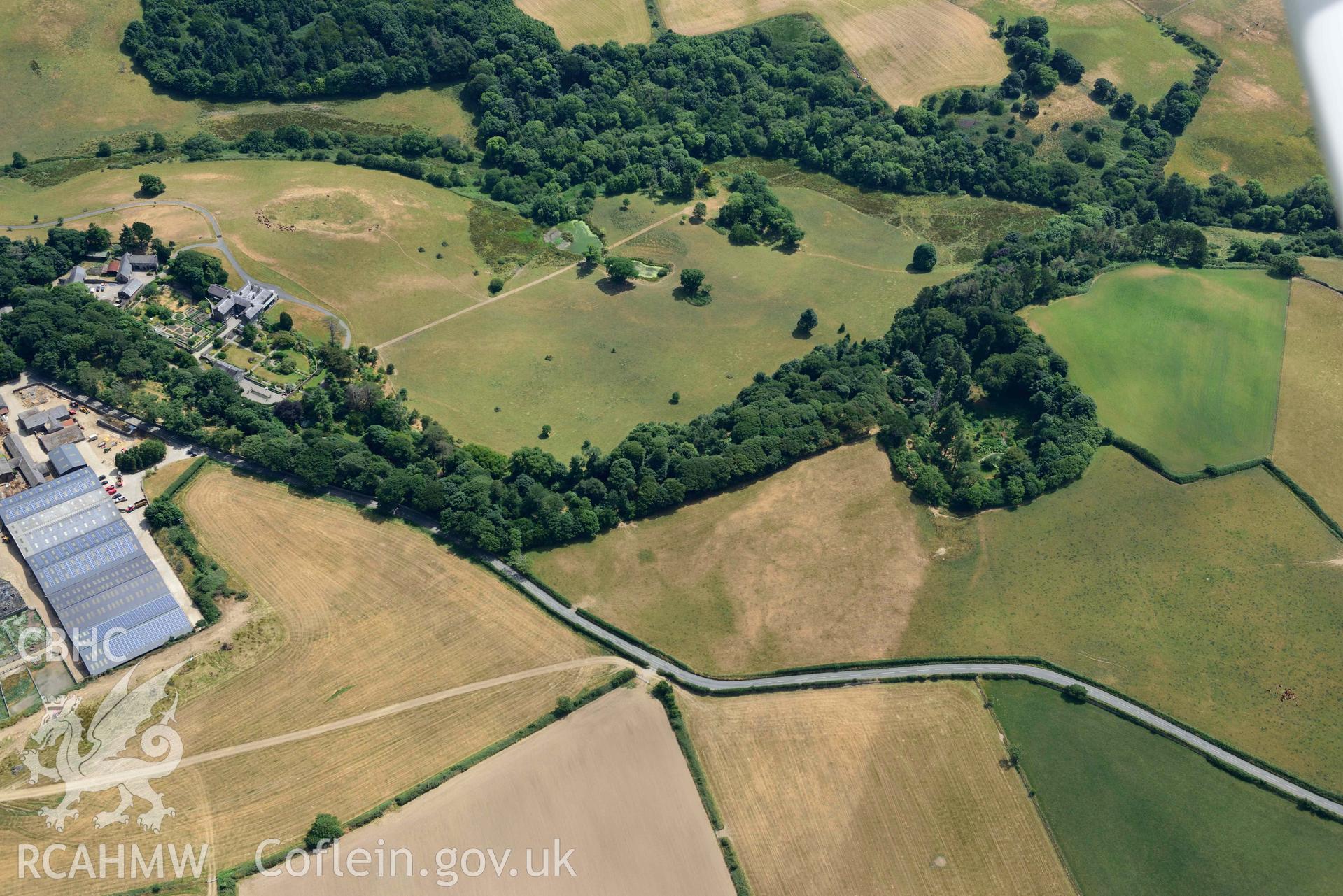 Coed Nant yr Alar enclosure with Nanhoron garden beyond. Oblique aerial photograph taken during the Royal Commission’s programme of archaeological aerial reconnaissance by Toby Driver on 10 July 2018.