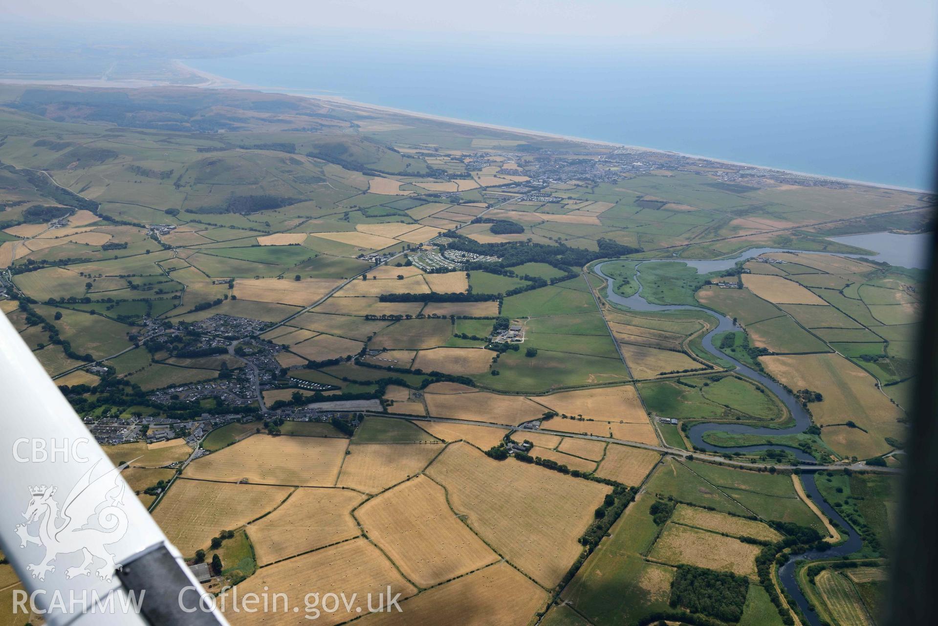 Landscape around enclosures to the west of Gwyddelfynydd, part of the Bryncrug cropmarks complex. Oblique aerial photograph taken during the Royal Commission’s programme of archaeological aerial reconnaissance by Toby Driver on 10 July 2018.