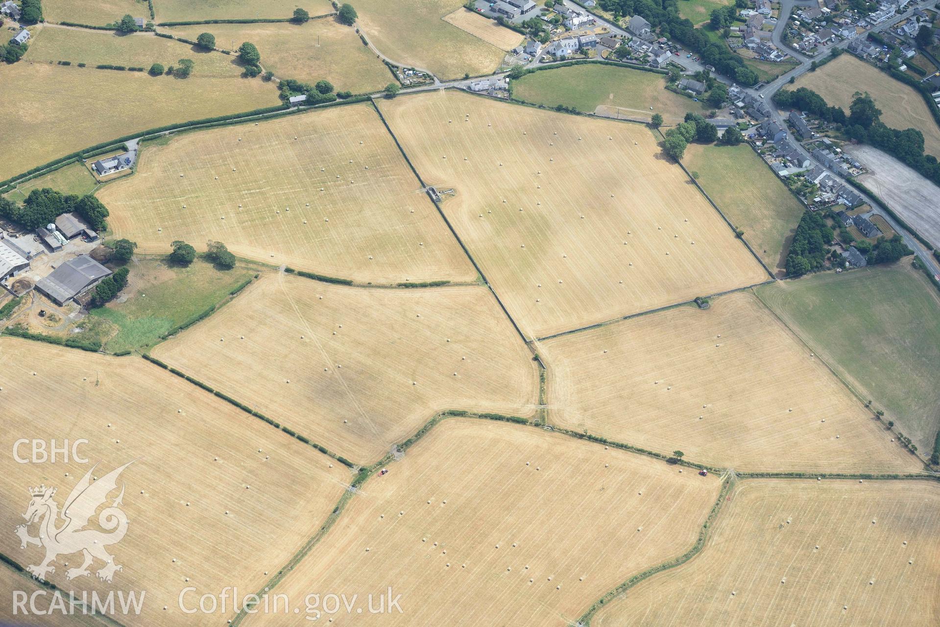 Enclosures to the west of Gwyddelfynydd, part of the Bryncrug cropmarks complex. Oblique aerial photograph taken during the Royal Commission’s programme of archaeological aerial reconnaissance by Toby Driver on 10 July 2018.