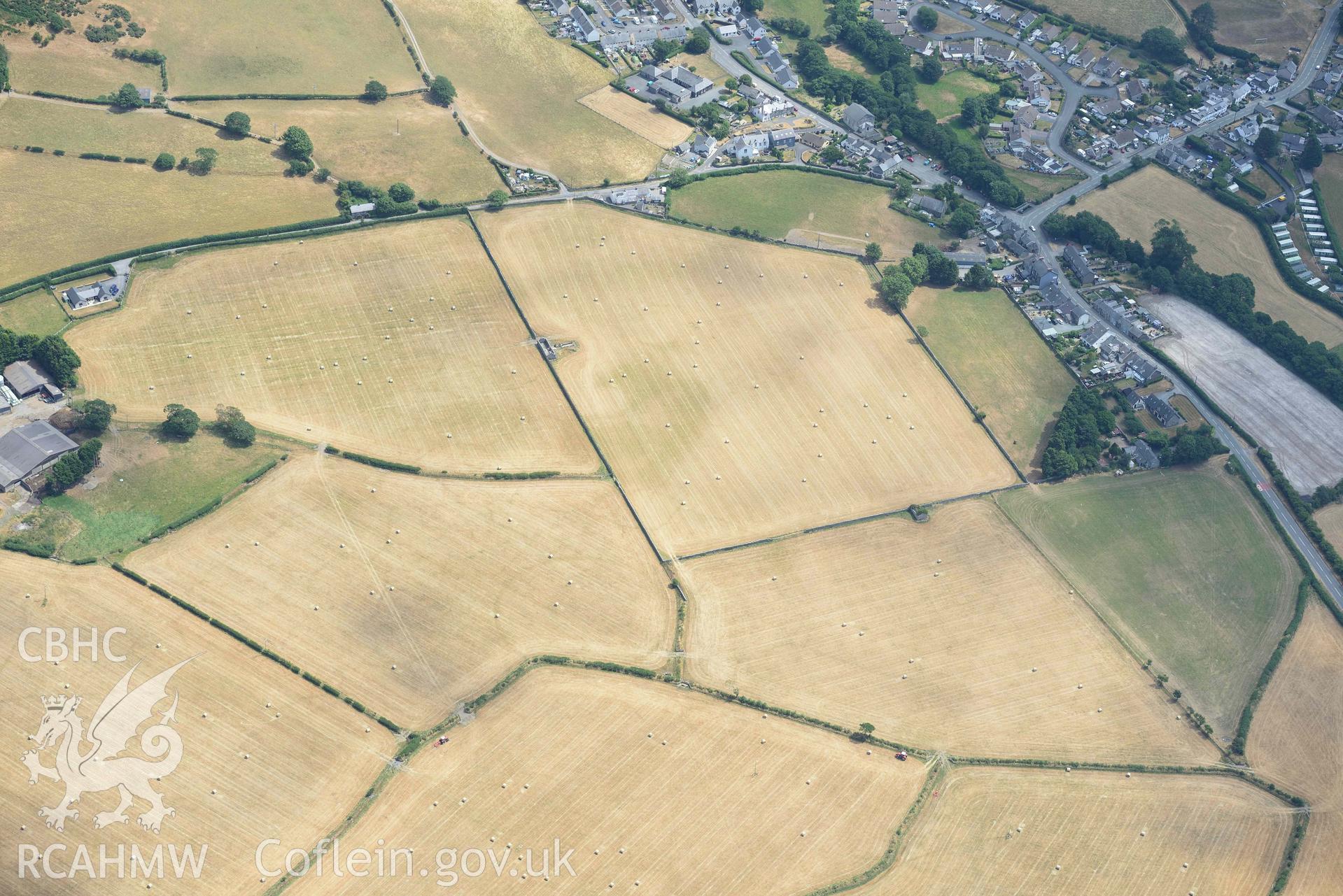 Enclosures to the west of Gwyddelfynydd, part of the Bryncrug cropmarks complex. Oblique aerial photograph taken during the Royal Commission’s programme of archaeological aerial reconnaissance by Toby Driver on 10 July 2018.