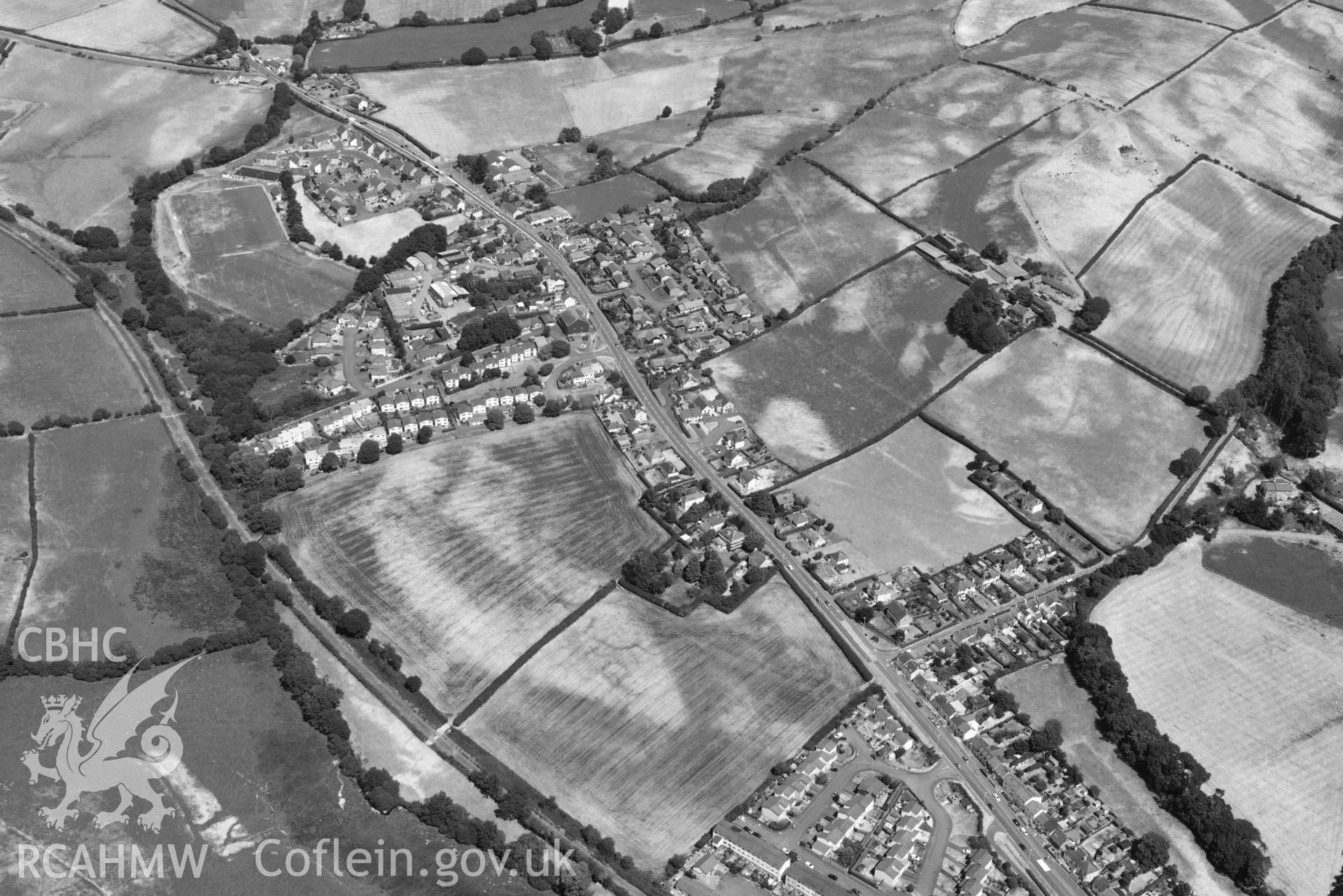 Caergywydd. Oblique black and white aerial photograph taken during the Royal Commission’s programme of archaeological aerial reconnaissance by Toby Driver on 10 July 2018.