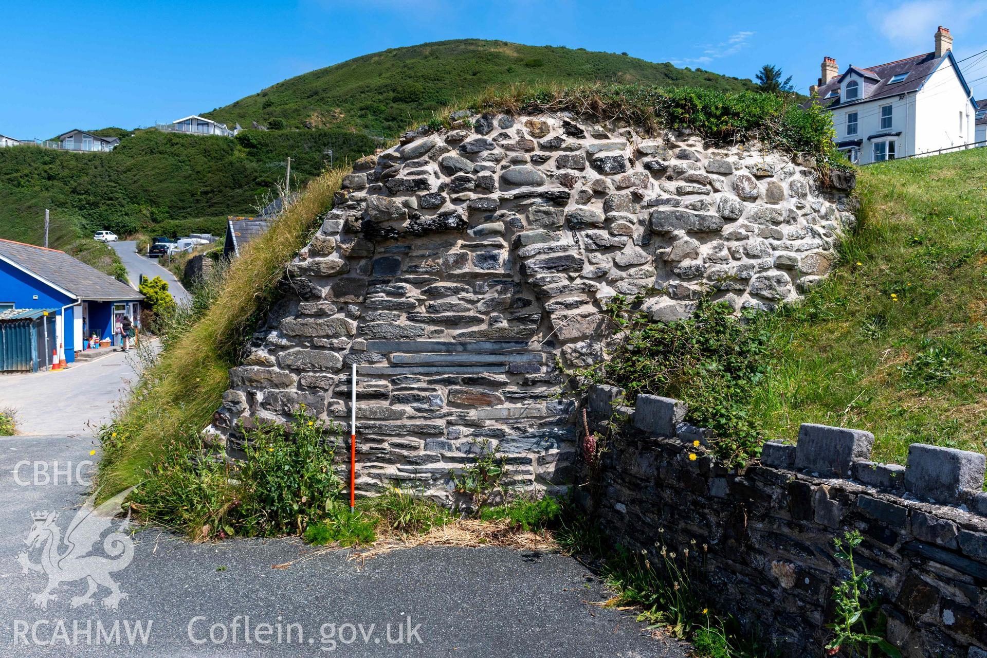 Lime Kiln 2, Tresaith. Surviving section of southwest wall and kiln-eye (with scale).