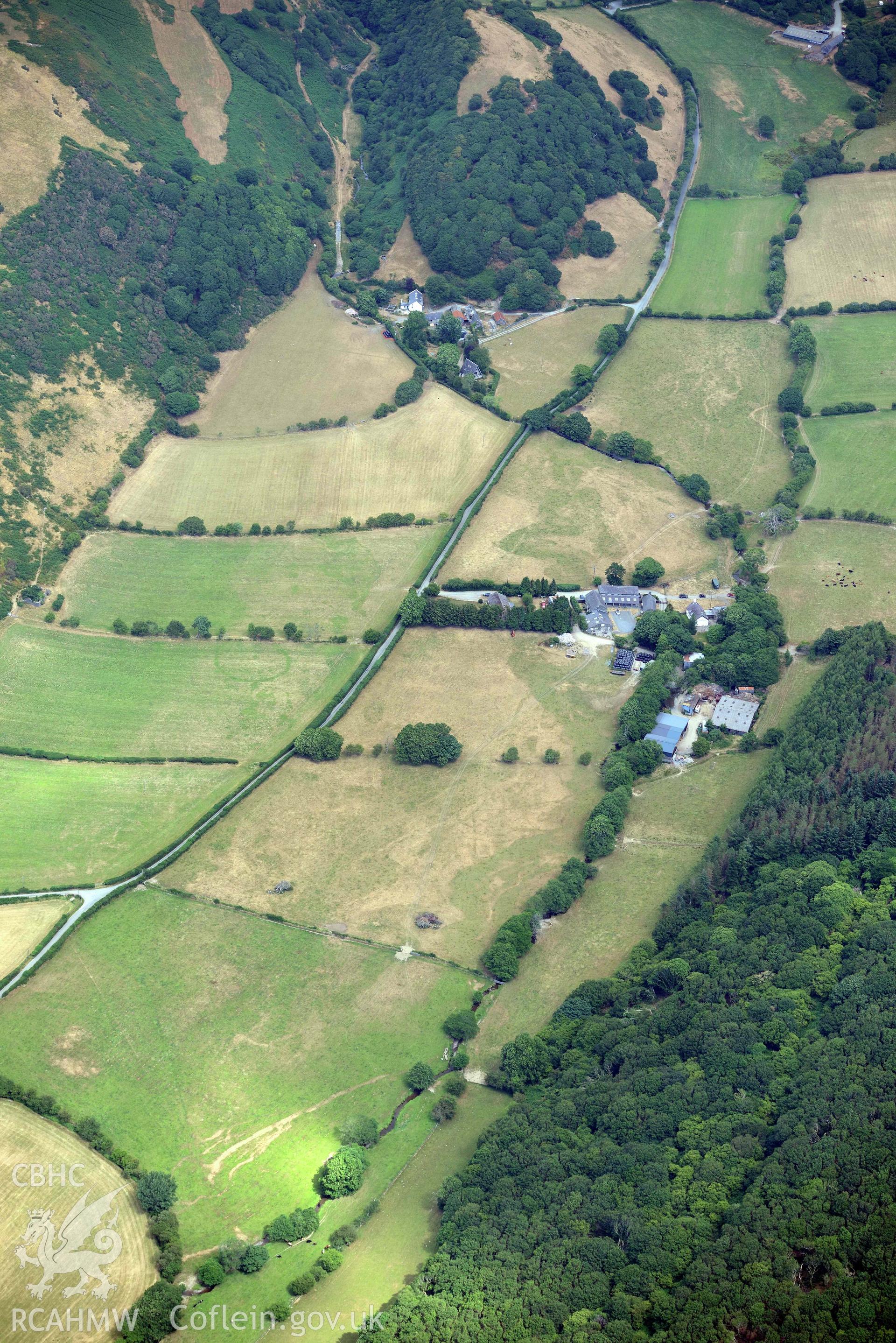 Ringditch cropmark at Dyffryn Gwyn and rectangular enclosure at Bryn Dinas. Oblique aerial photograph taken during the Royal Commission’s programme of archaeological aerial reconnaissance by Toby Driver on 10 July 2018.